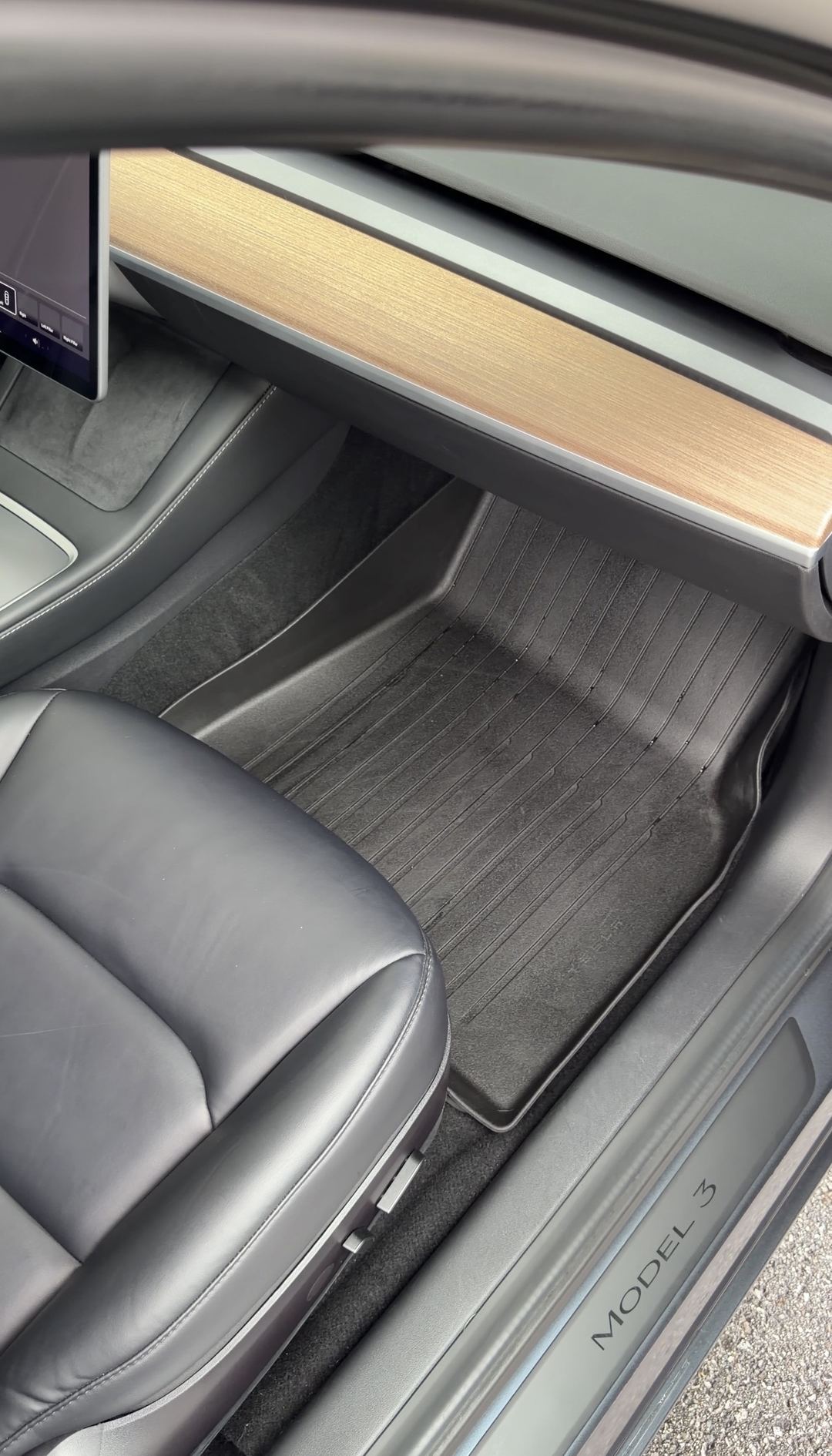 Tesla Model 3 front passenger footwell after cleaning, rubber mat and carpet free of dust