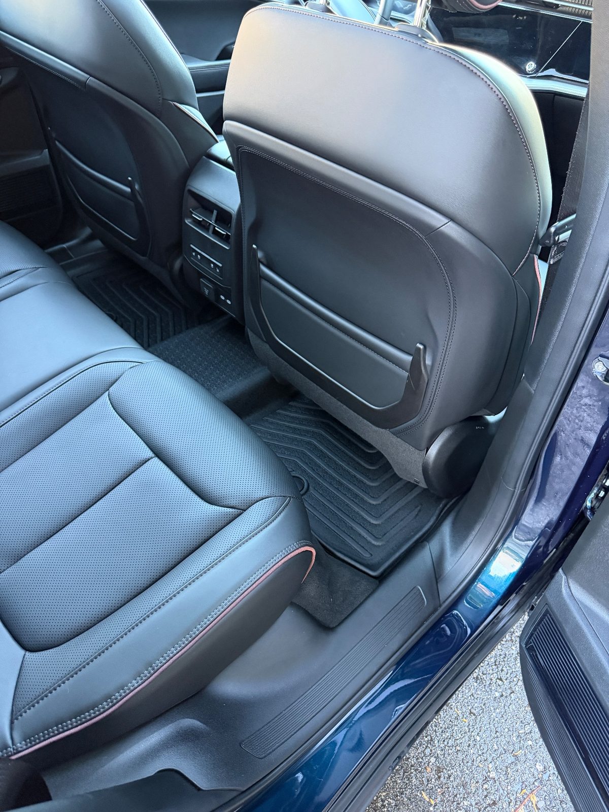 Clean rear footwell of a Jeep Wagoneer S after detailing