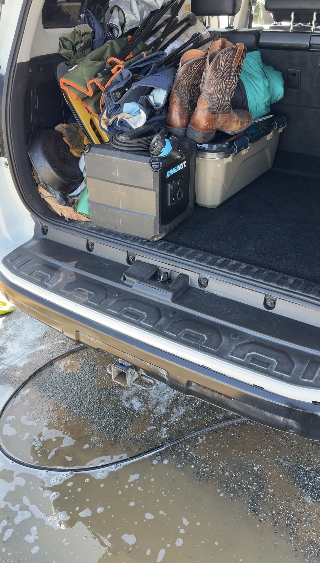 Clean rear bumper step of a Toyota 4Runner with camping gear loaded in the cargo area