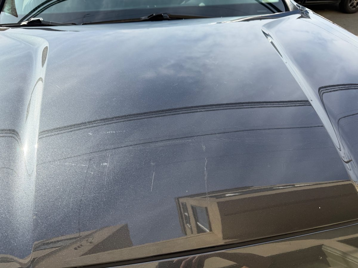 Hairline scratches across the hood of a grey Hyundai Santa Fe before paint work