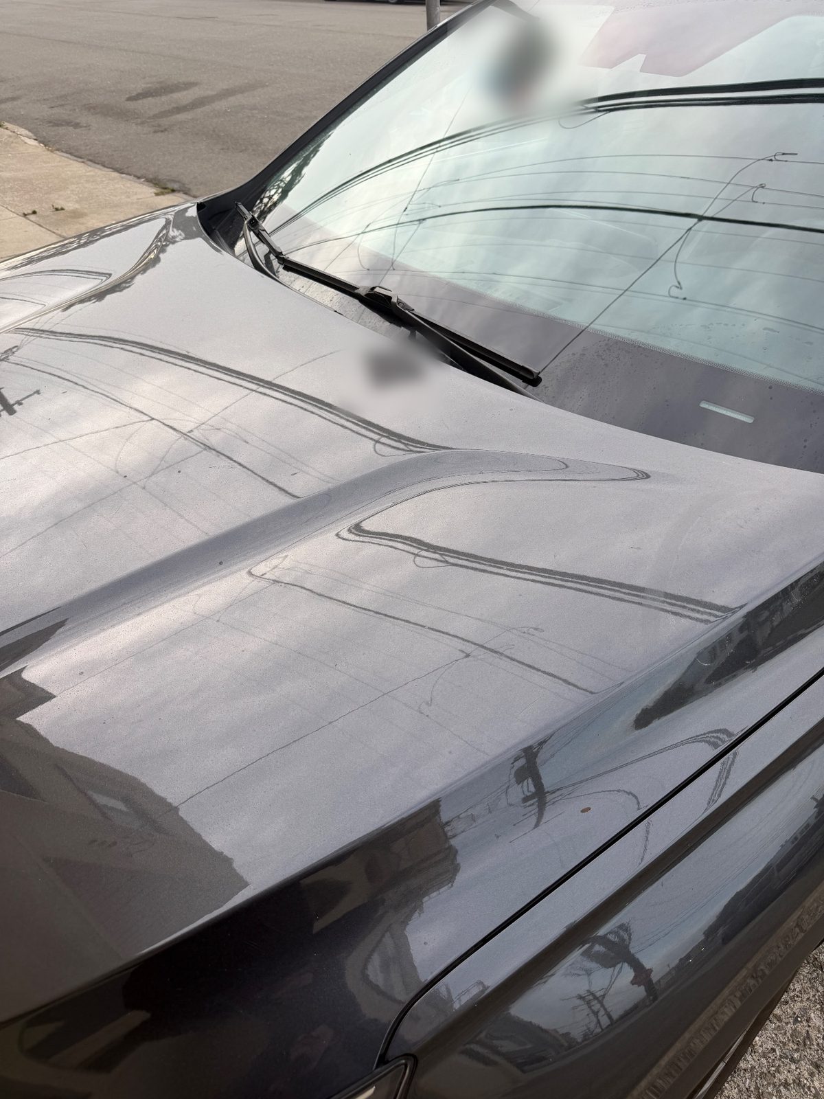Dusty hood and windshield of a Hyundai Santa Fe before detailing