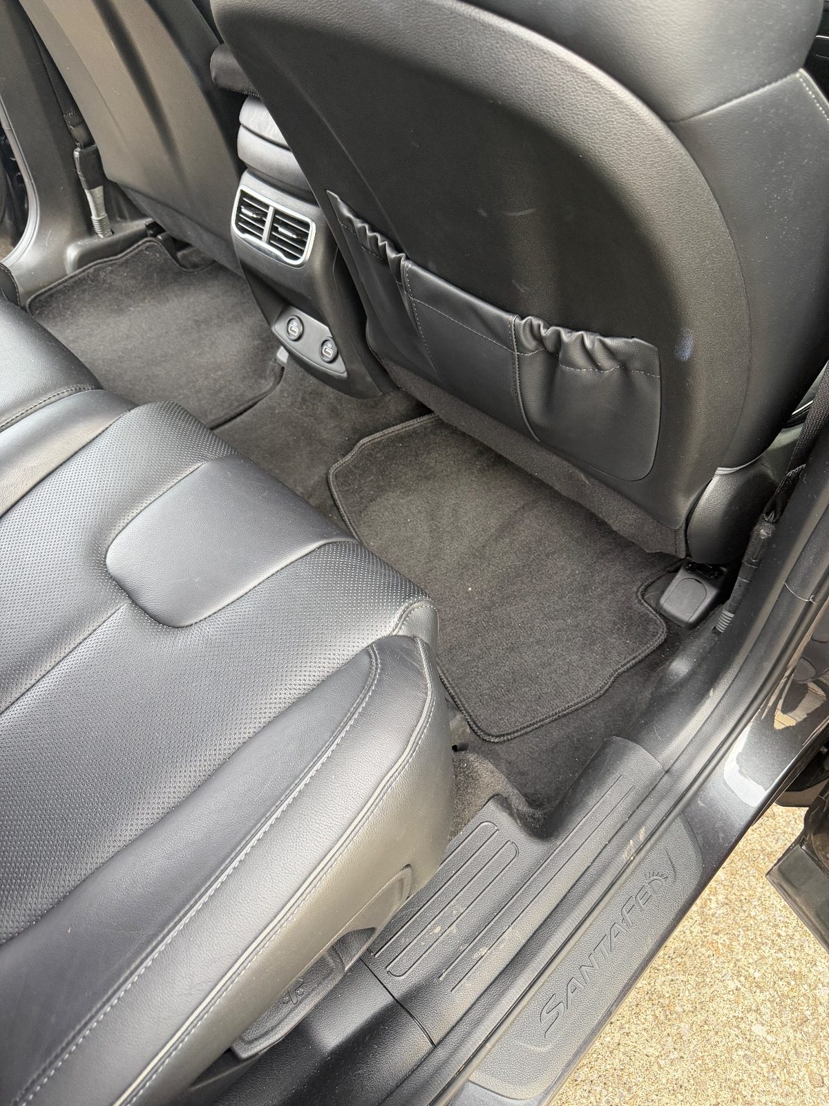 Rear footwell carpet of a Hyundai Santa Fe before detailing, with lint and grit