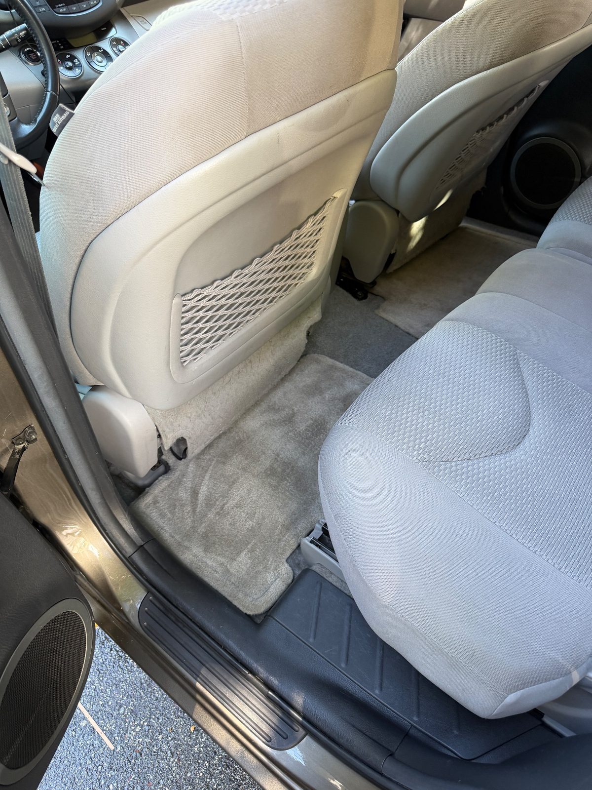 Rear driver-side footwell of a bronze Toyota RAV4 in the Inner Sunset, San Francisco, after detailing