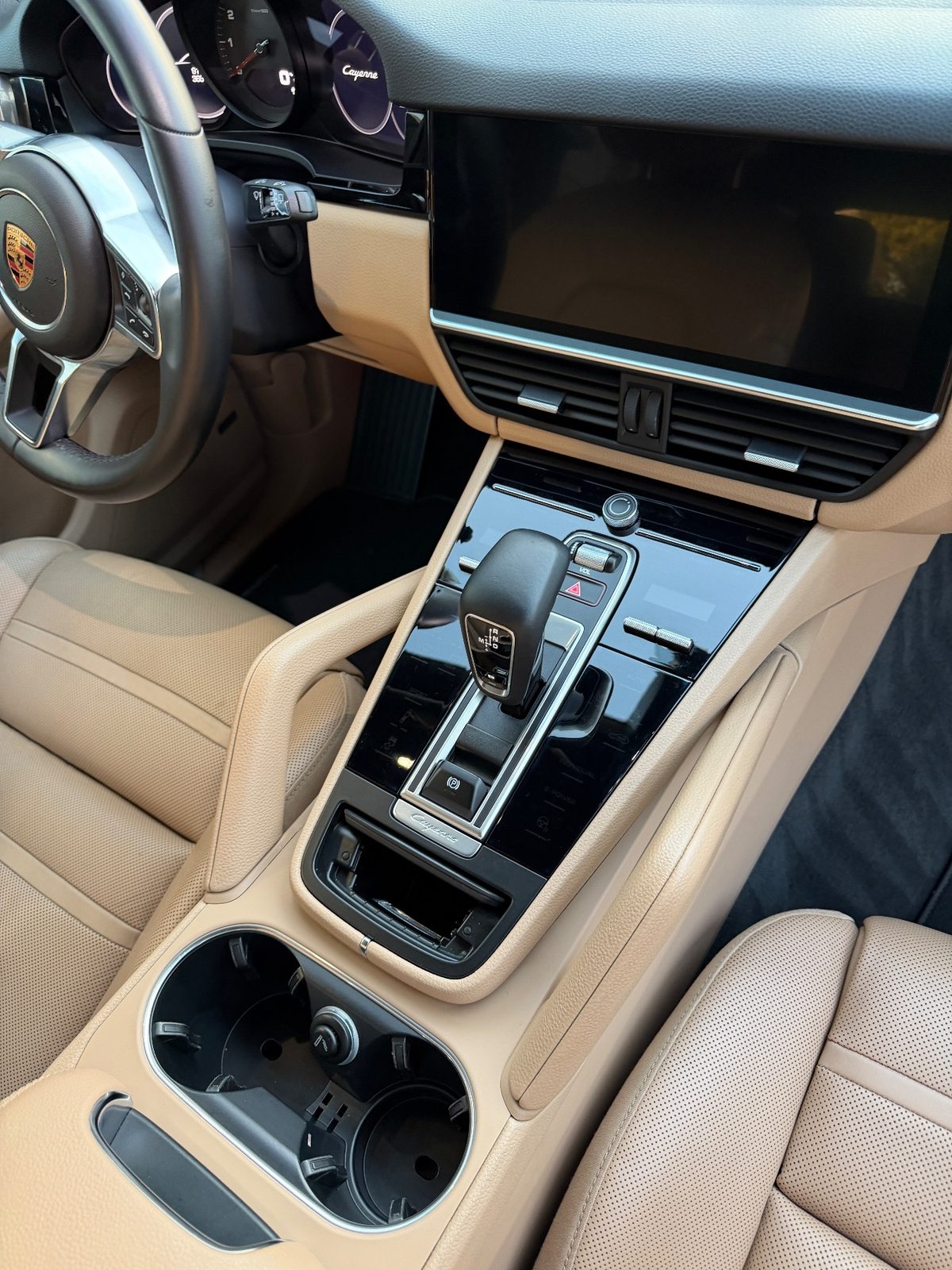 Clean centre console and dash of a Porsche Cayenne after detailing, gloss trim free of dust