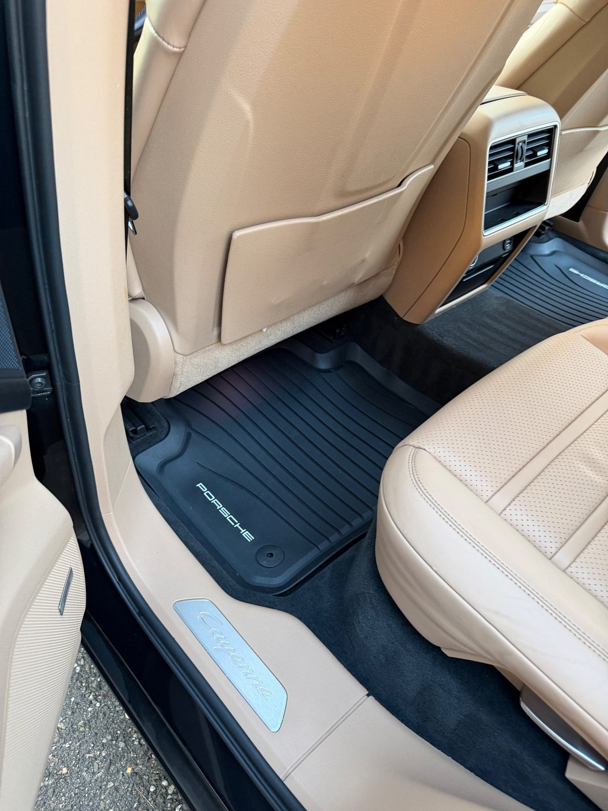 Clean rear footwell of a Porsche Cayenne after detailing, mat and pocket wiped down