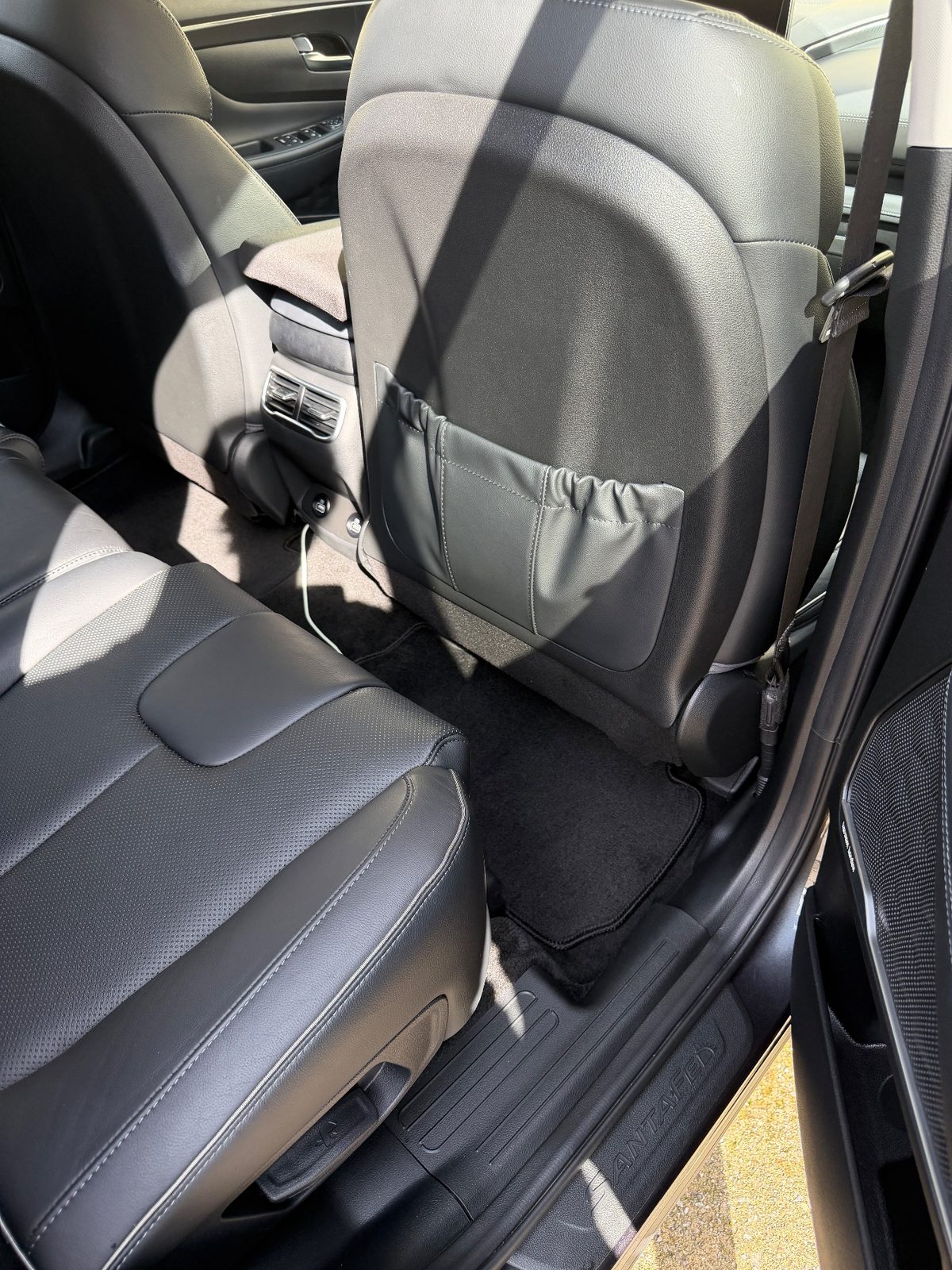 Vacuumed rear footwell carpet of a Hyundai Santa Fe after detailing