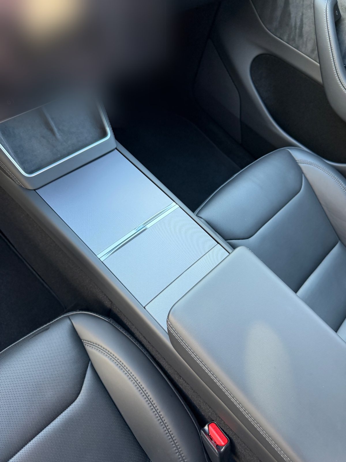 Clean centre console of a white Tesla Model Y after detailing