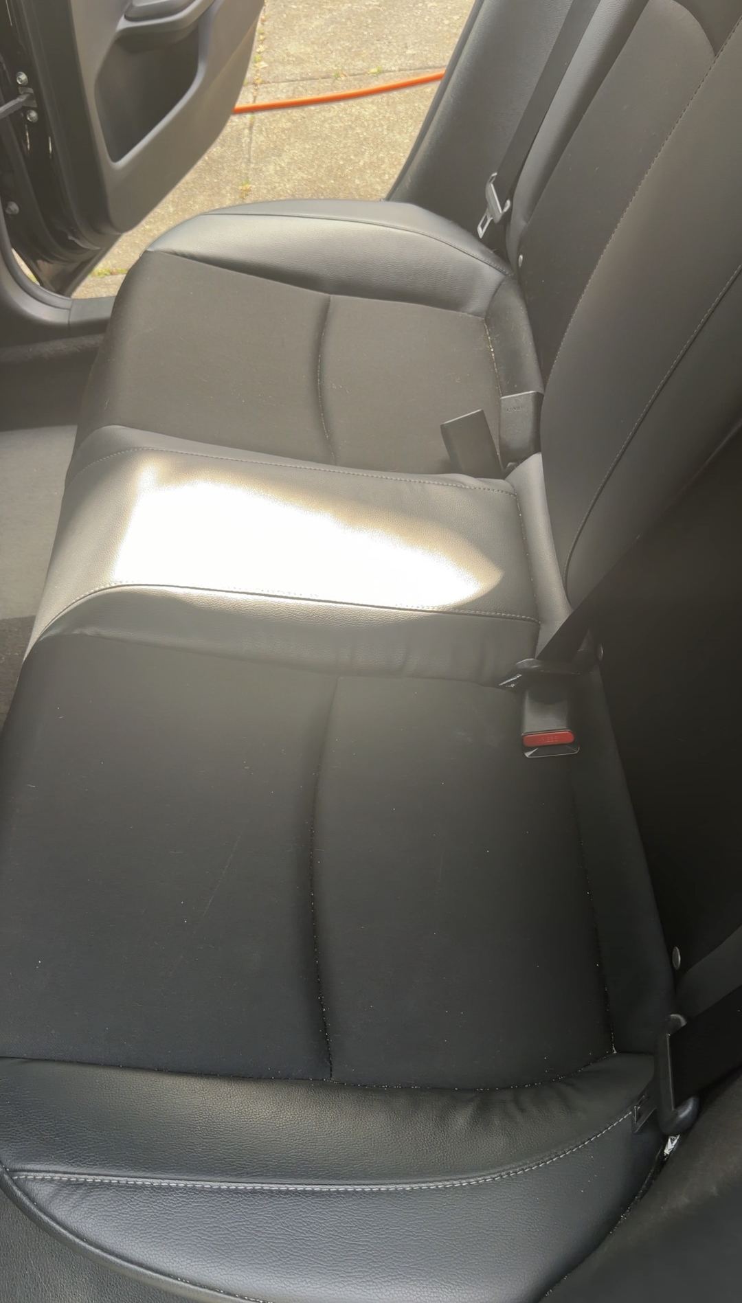 Rear bench seat of a Honda Civic before steam cleaning and extraction