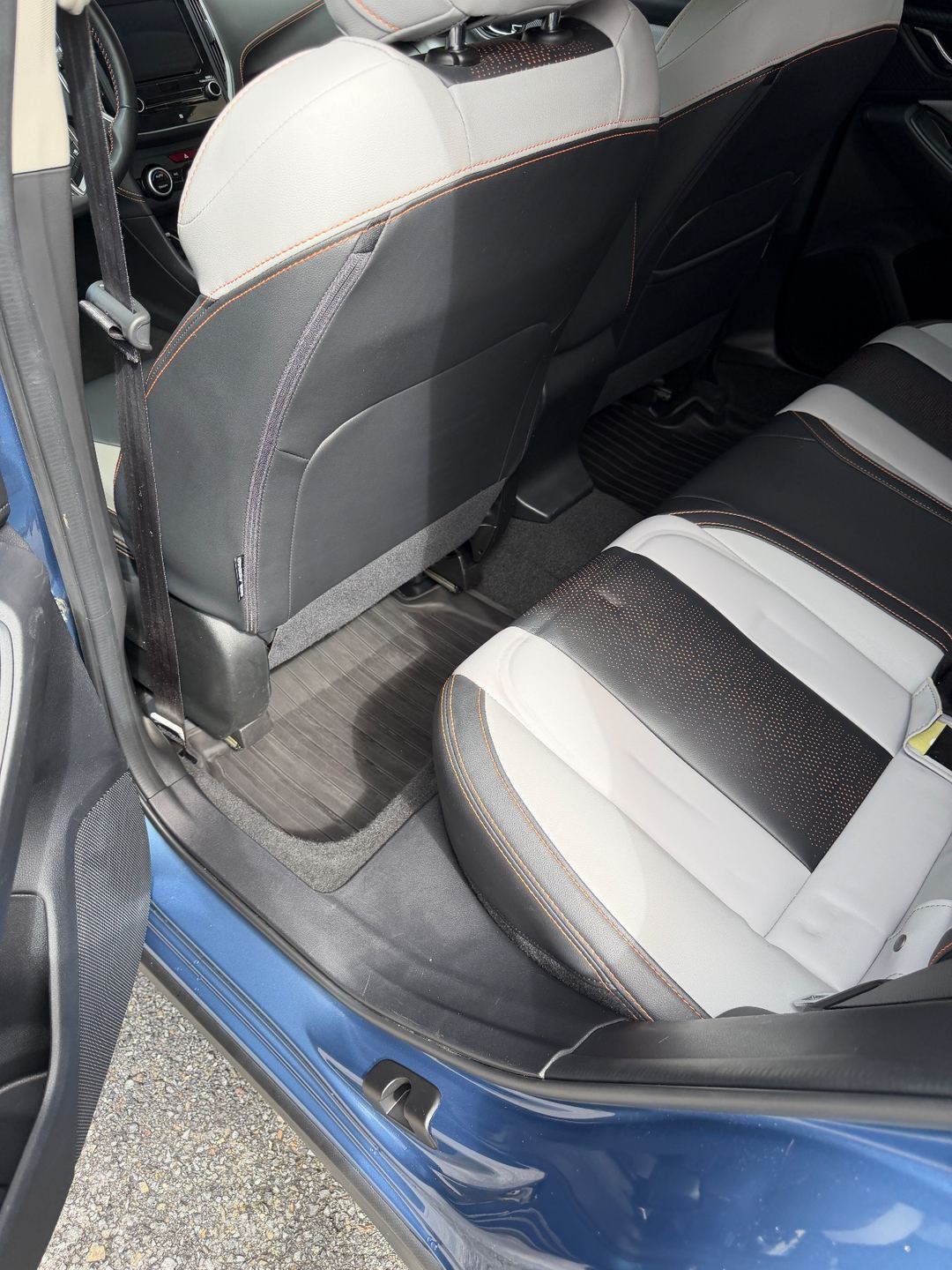 Clean rear footwell and bench seat of a Subaru Crosstrek after detailing