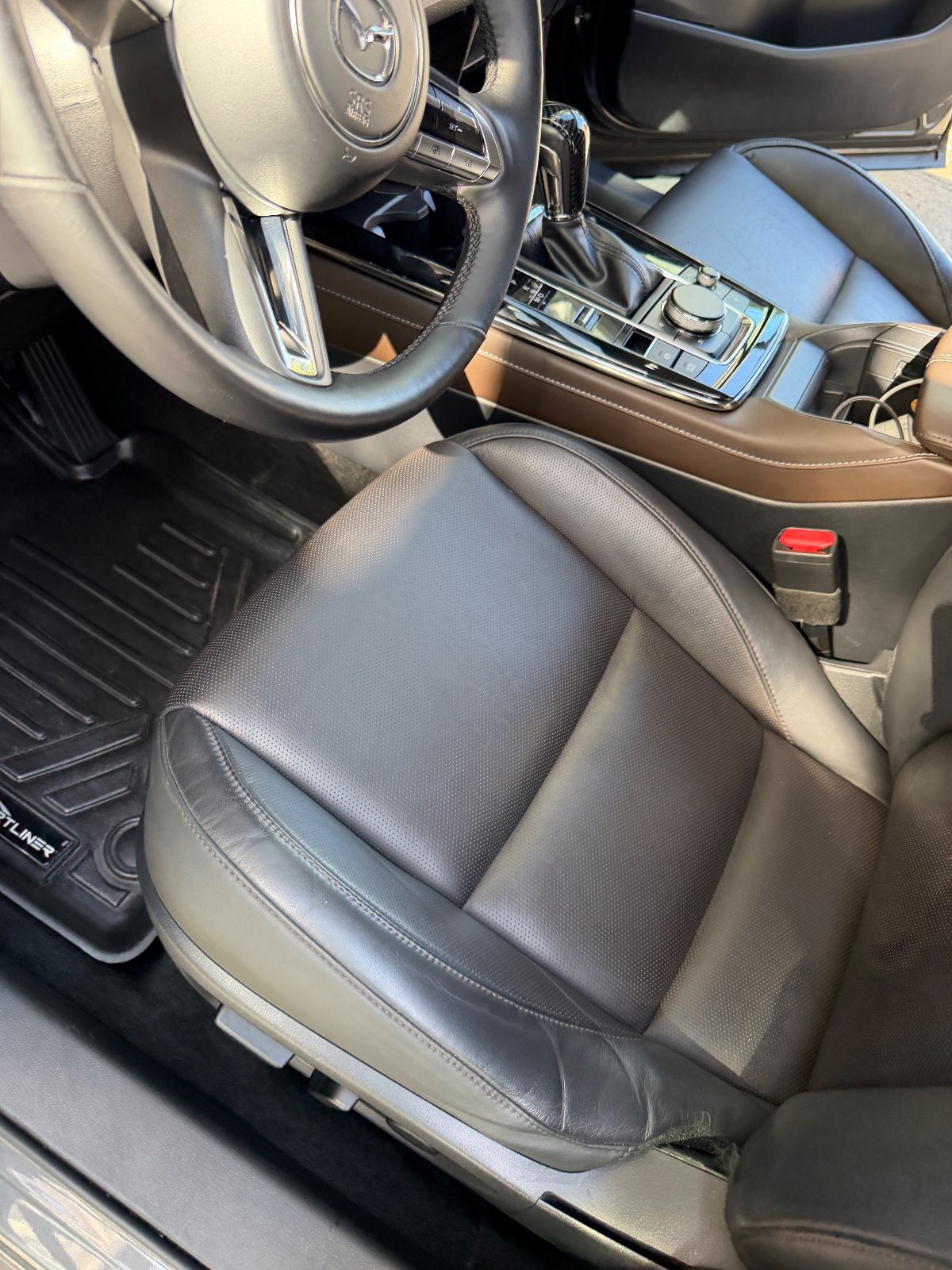 Driver seat of a grey Mazda CX-30 after detailing, leather clean