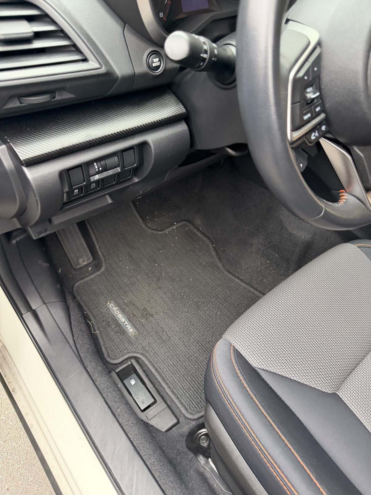 Driver footwell of a white Subaru Crosstrek in the Inner Richmond, San Francisco, before detailing