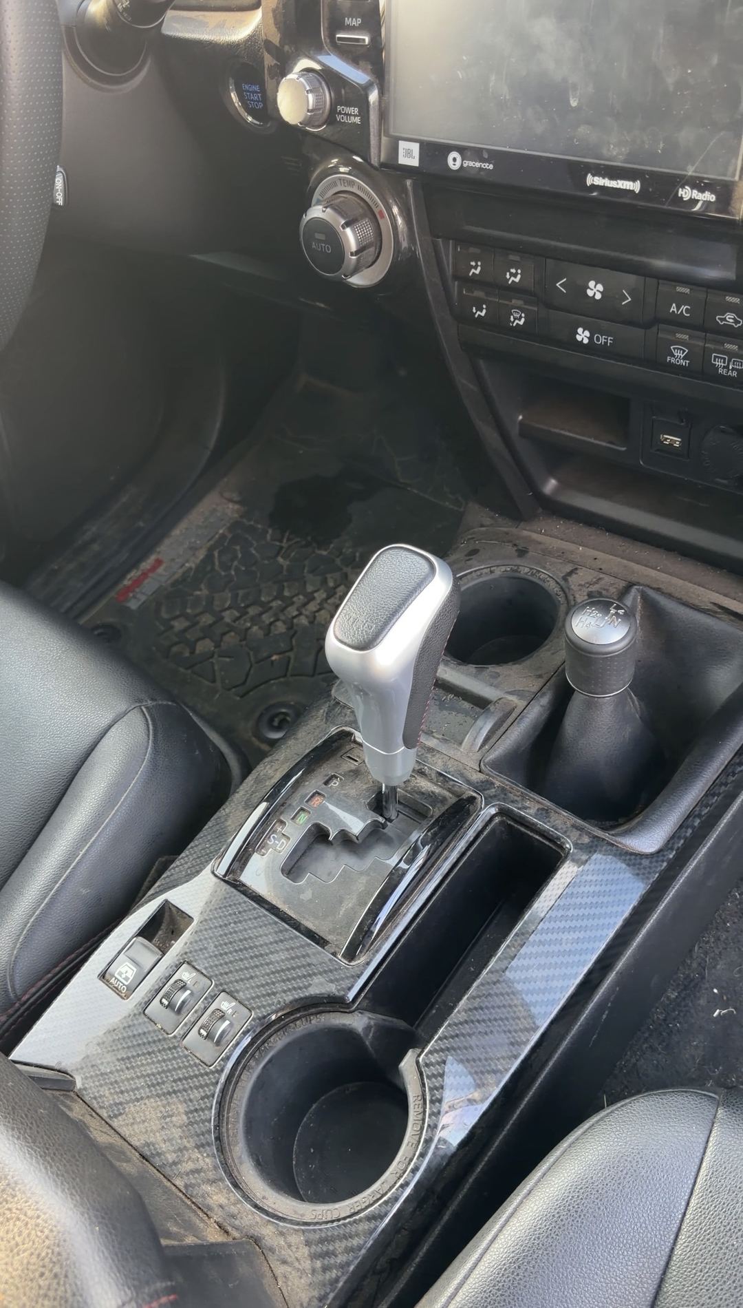 Dusty center console with carbon-pattern trim and shifter in a Toyota 4Runner