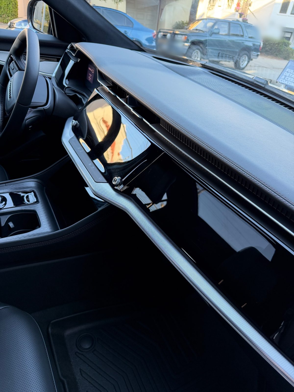Dash and glossy trim of a Jeep Wagoneer S interior after detailing
