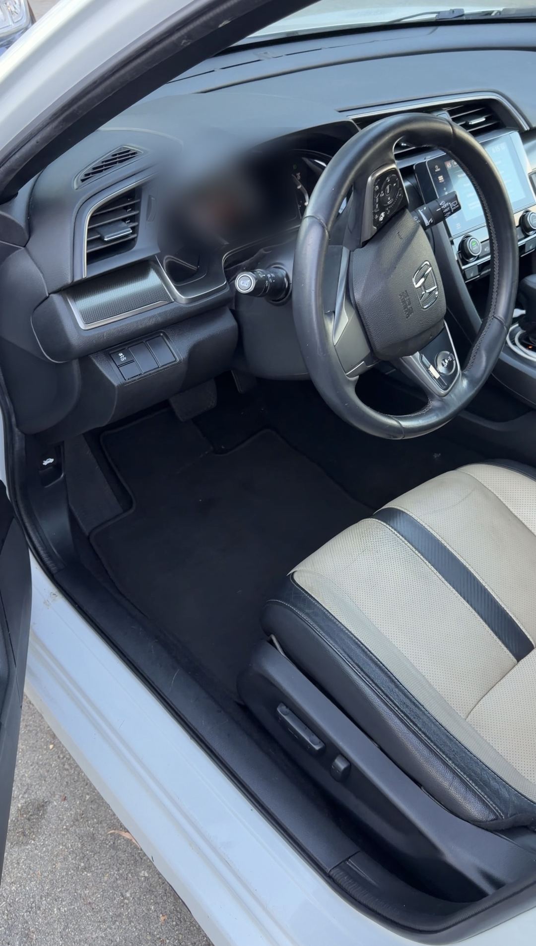 Cleaned driver footwell, dash and steering wheel of a Honda Civic after interior detailing