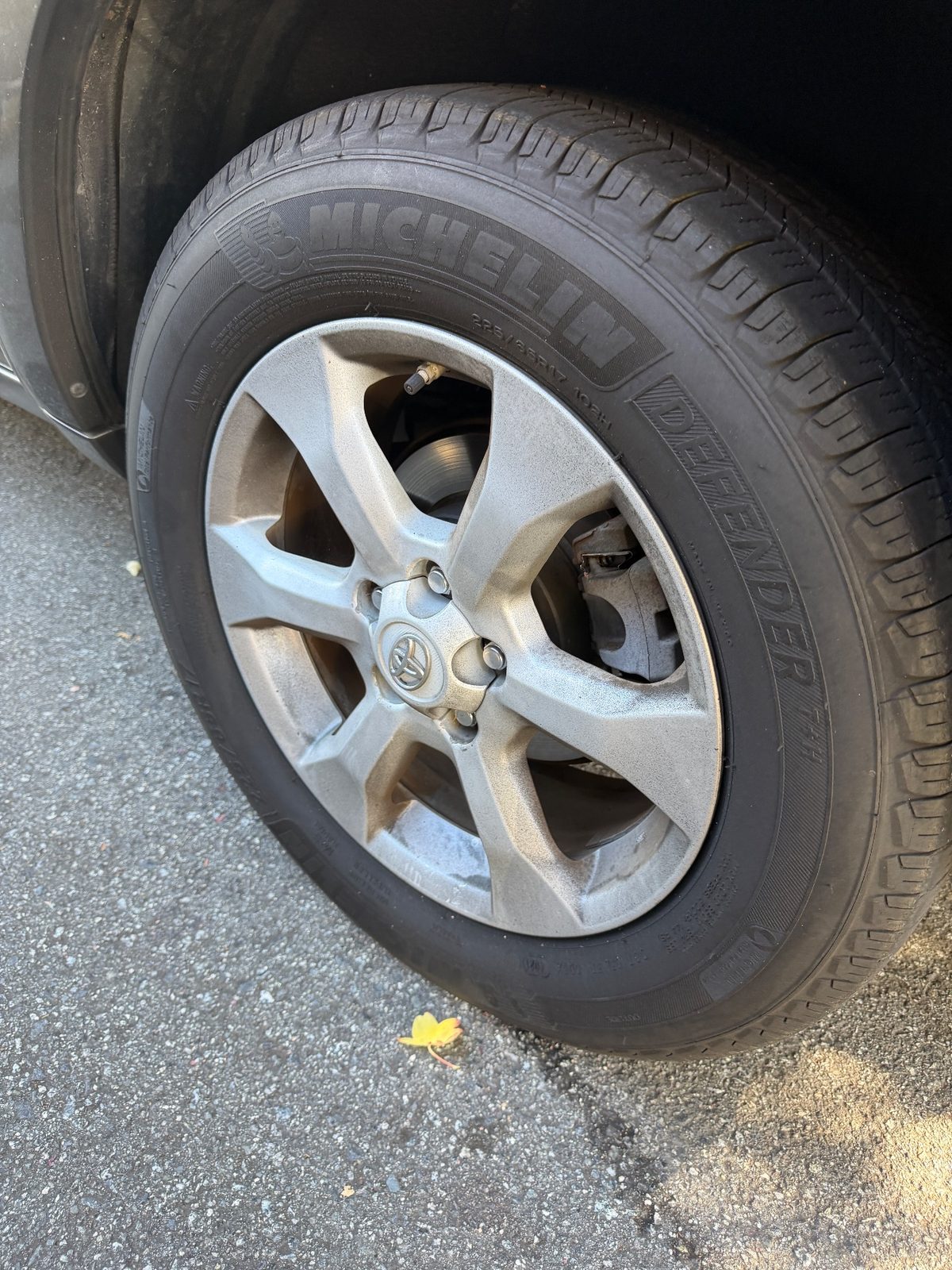 Dirty alloy wheel and dull tyre on a 2011 Toyota RAV4 before cleaning