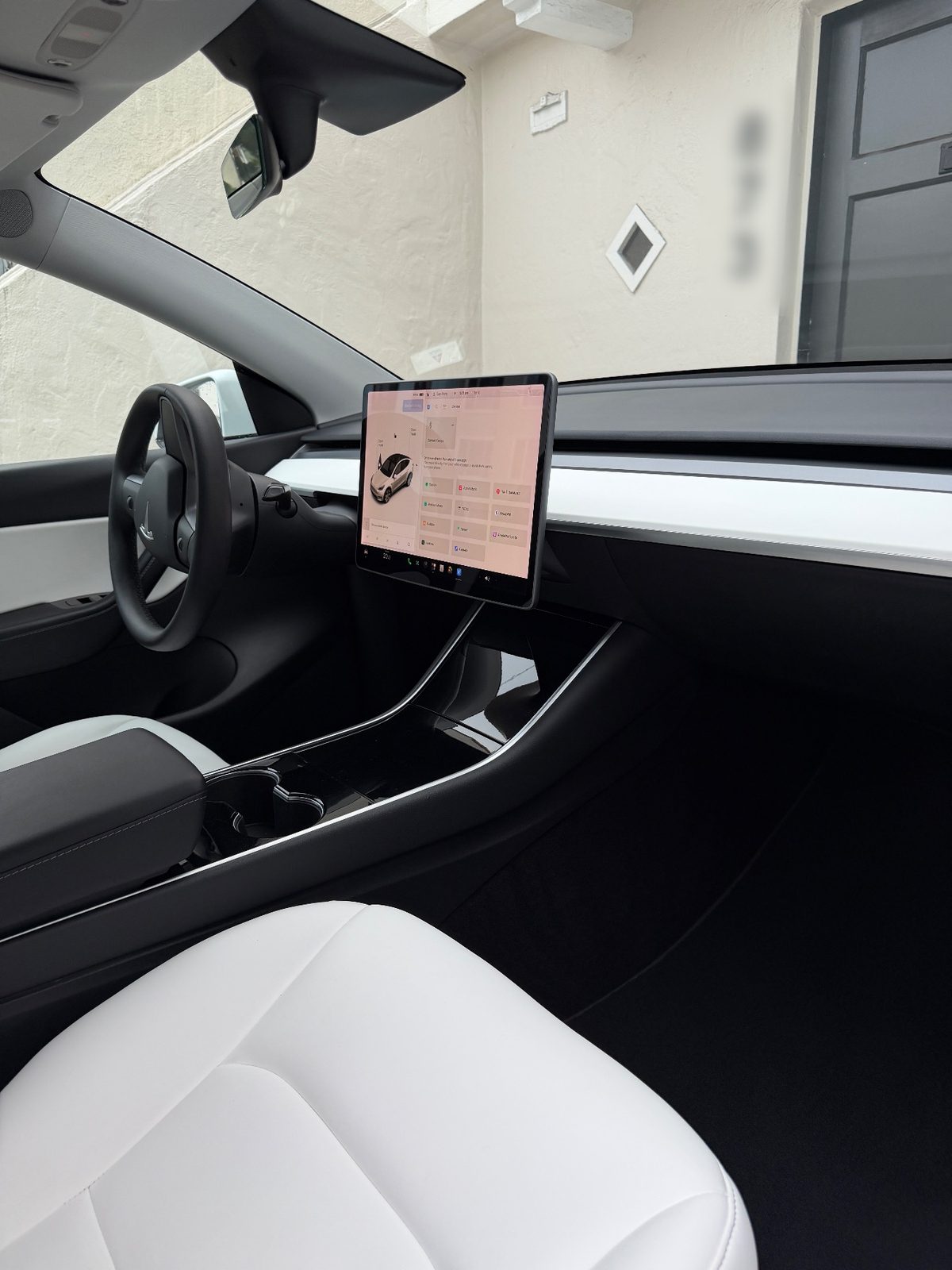 Dashboard and cabin of a white Tesla Model Y after detailing