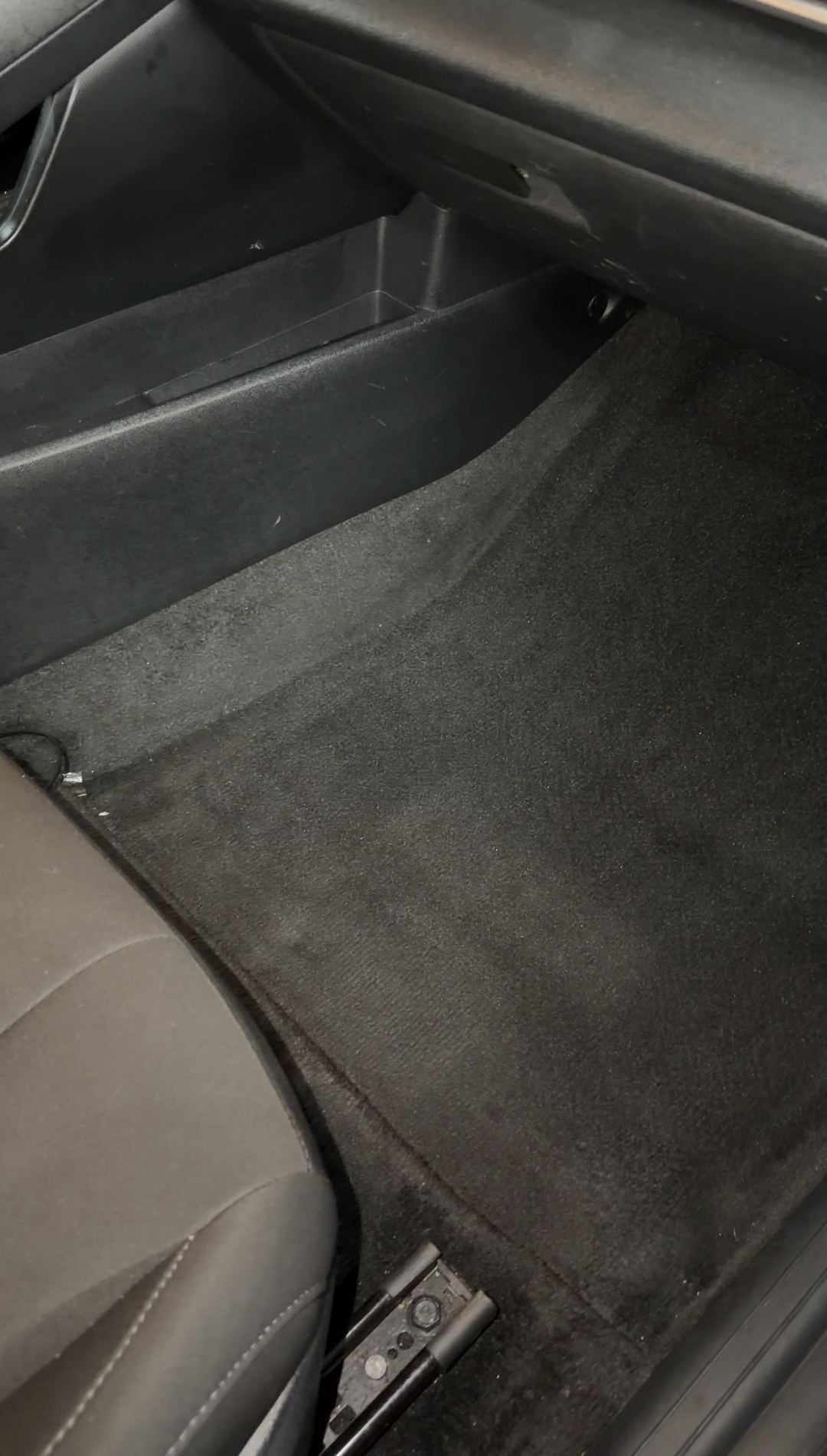 Front passenger footwell carpet in a Hyundai Elantra with the floor mat removed
