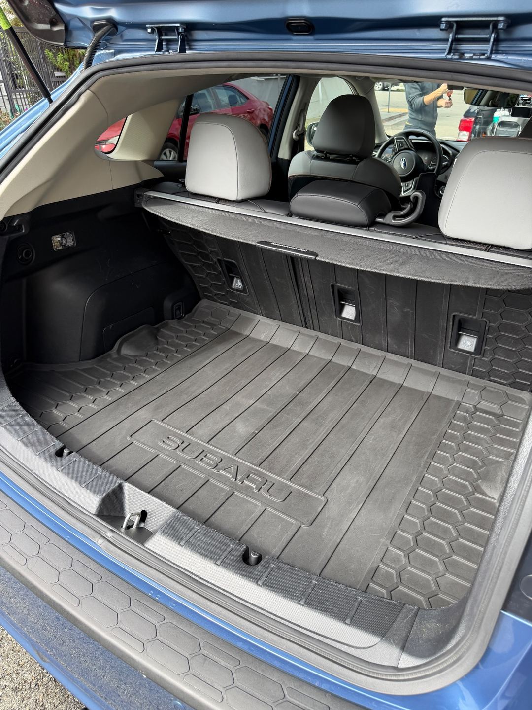 Clean rubber cargo tray of a Subaru Crosstrek after detailing, the dirt smears gone