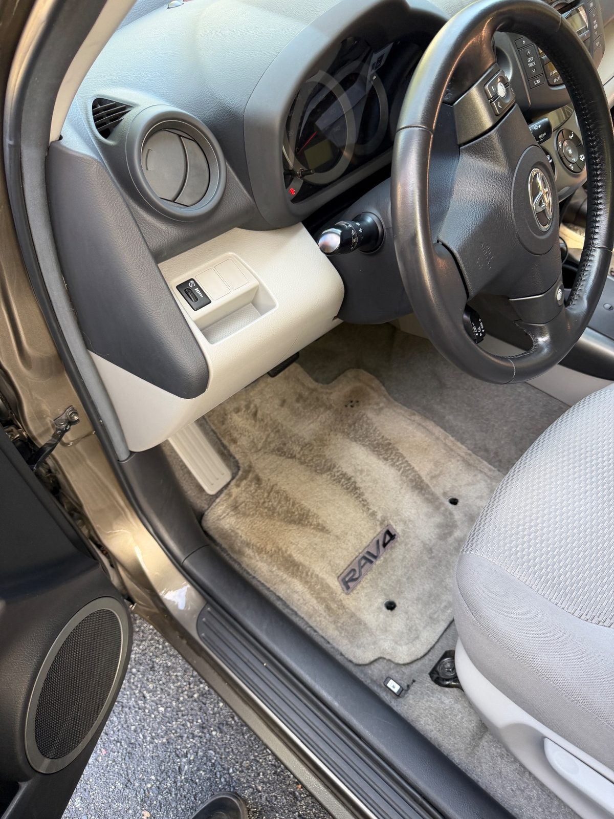 Vacuumed driver-side mat of a 2011 Toyota RAV4 after detailing