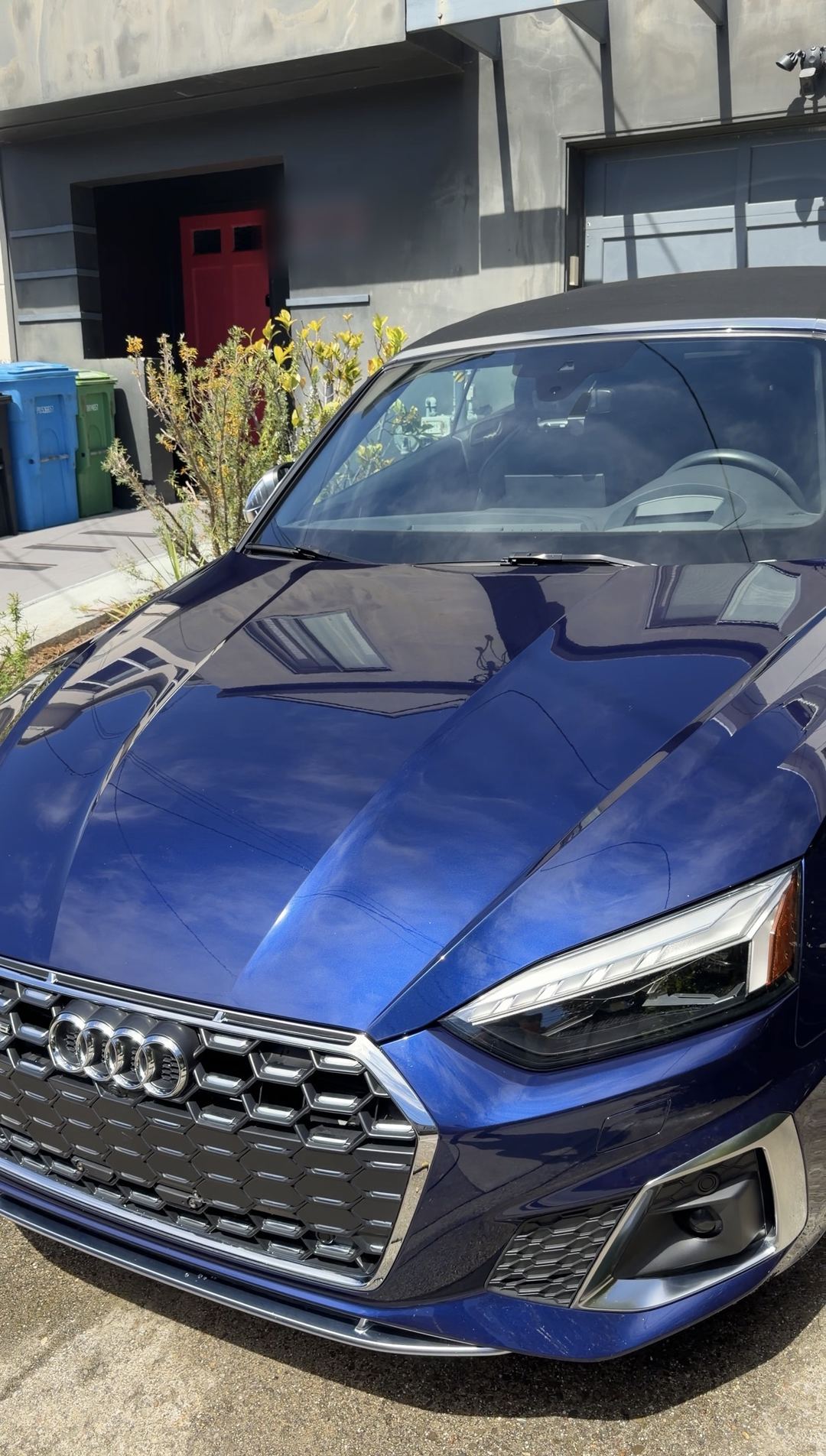 Clean blue Audi S5 Cabriolet front with honeycomb grille parked in a driveway