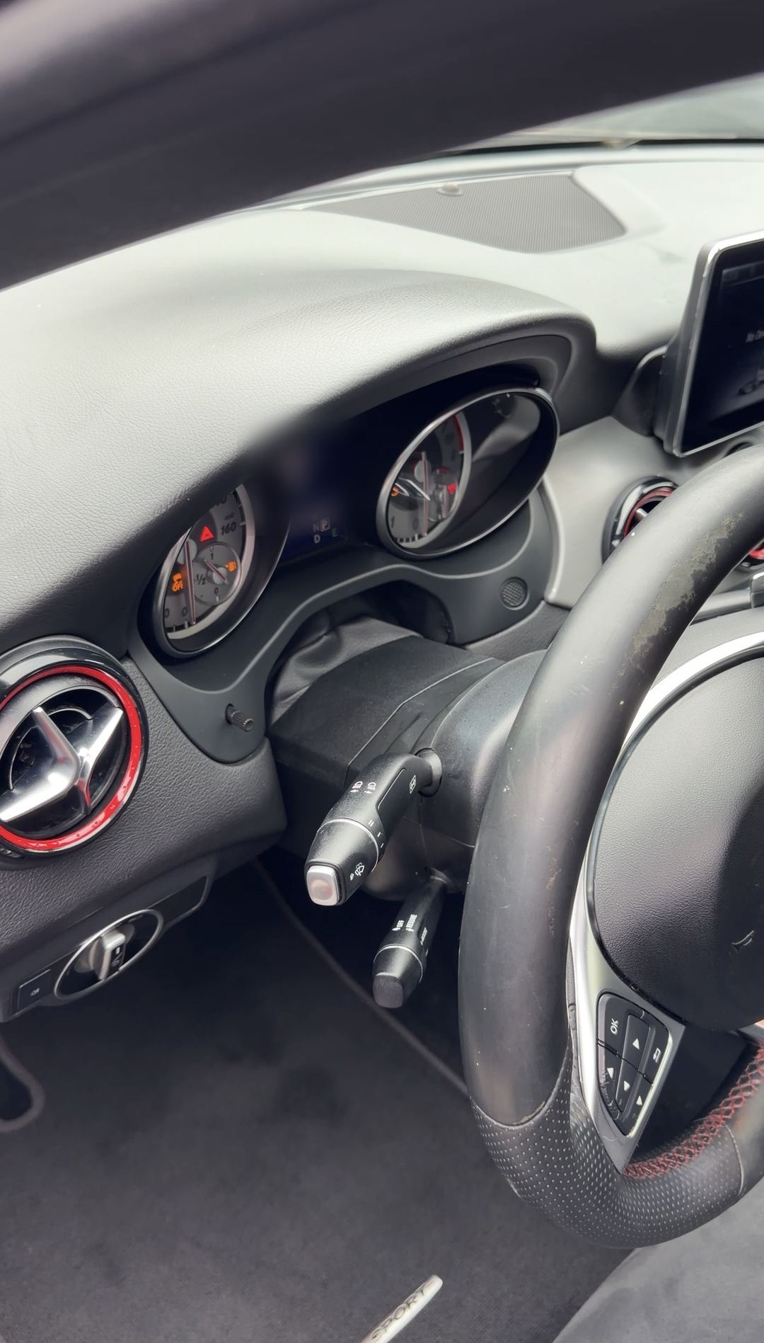Instrument cluster and red-ringed turbine air vent of a Mercedes-Benz CLA250