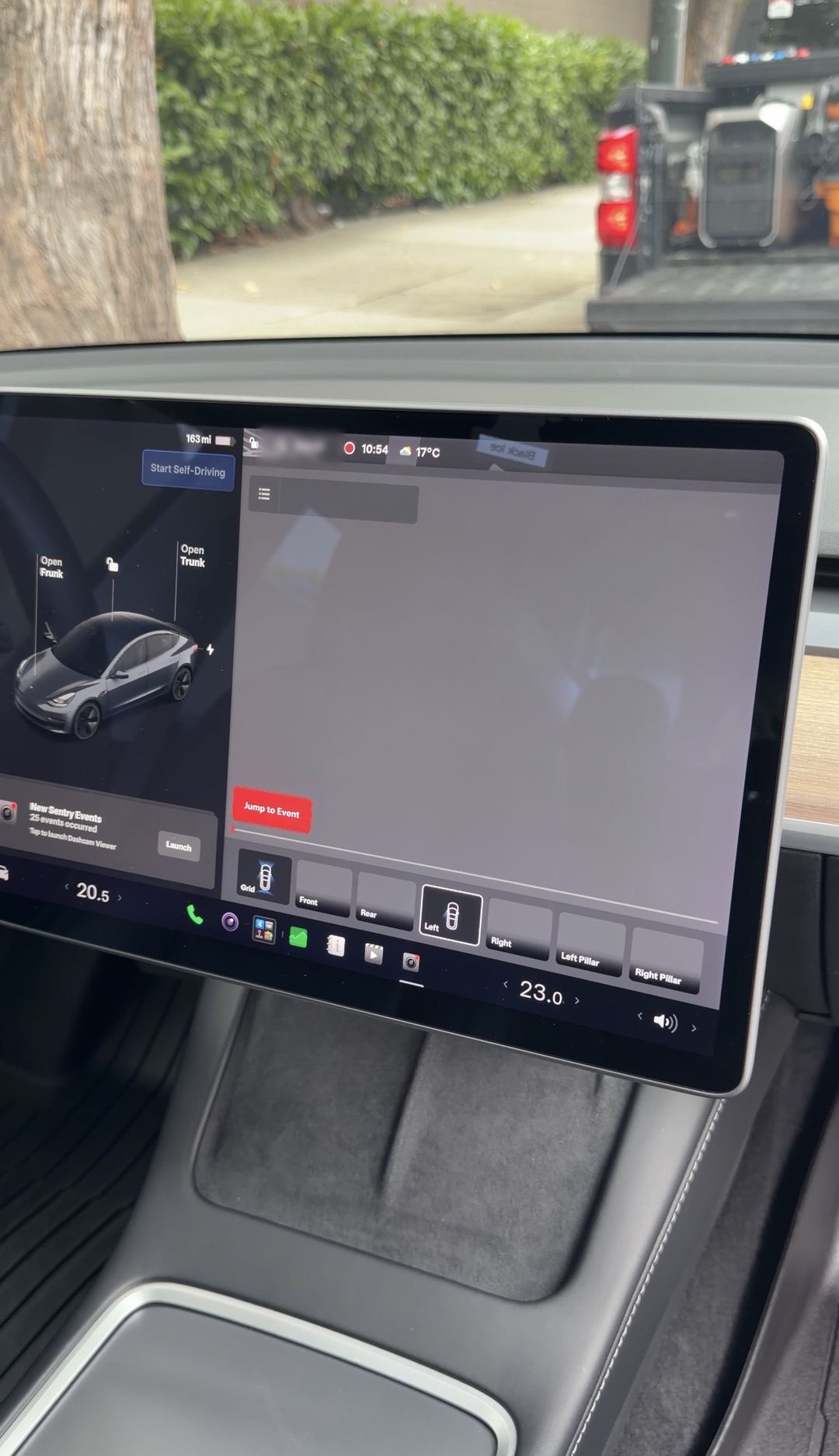 Tesla Model 3 touchscreen showing the dashcam viewer, with the center console below