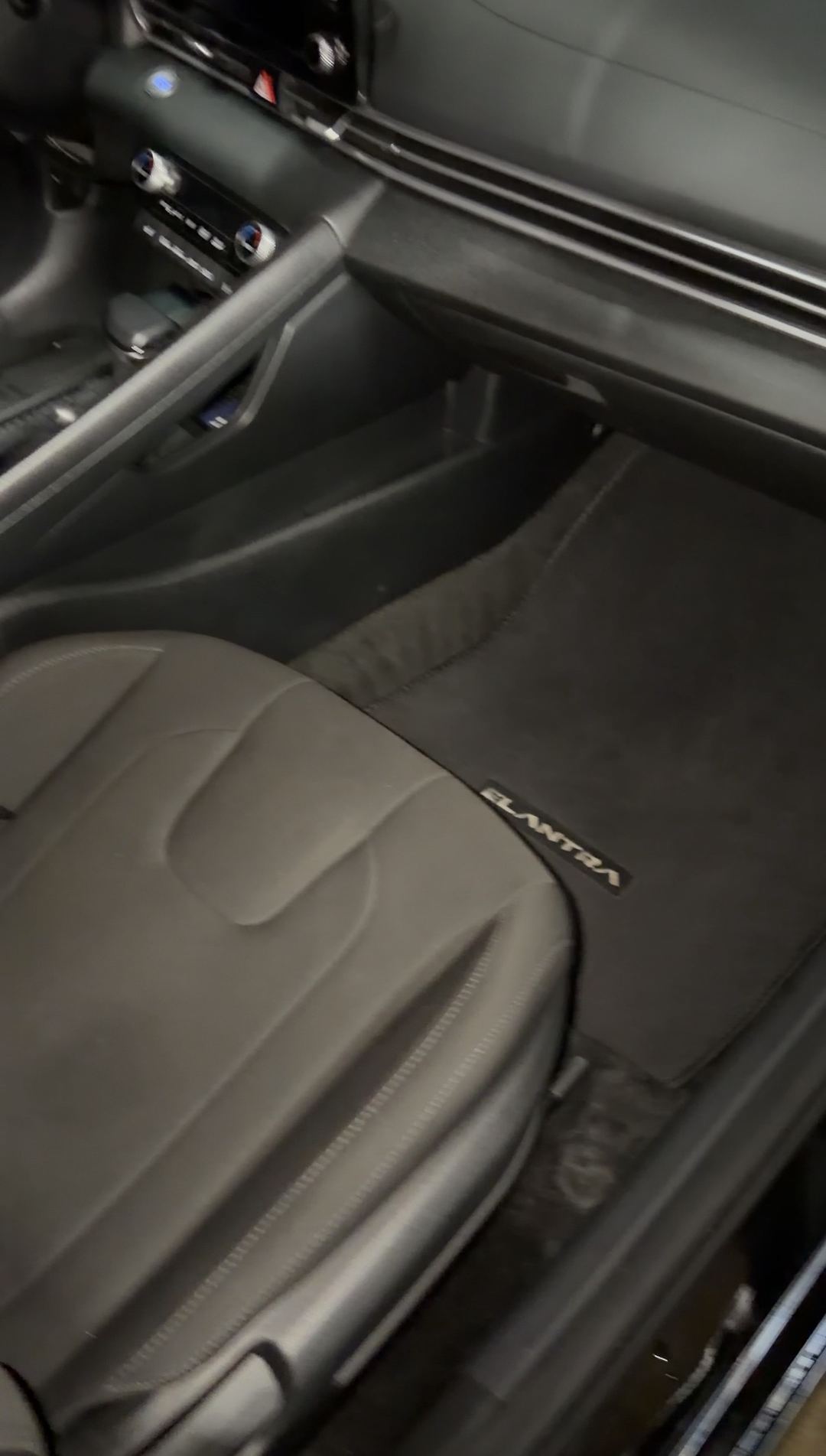 Clean front passenger seat and ELANTRA floor mat in a Hyundai Elantra after detailing
