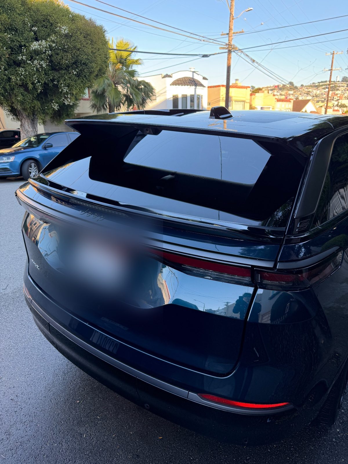 Rear of a clean dark blue Jeep Wagoneer S after detailing