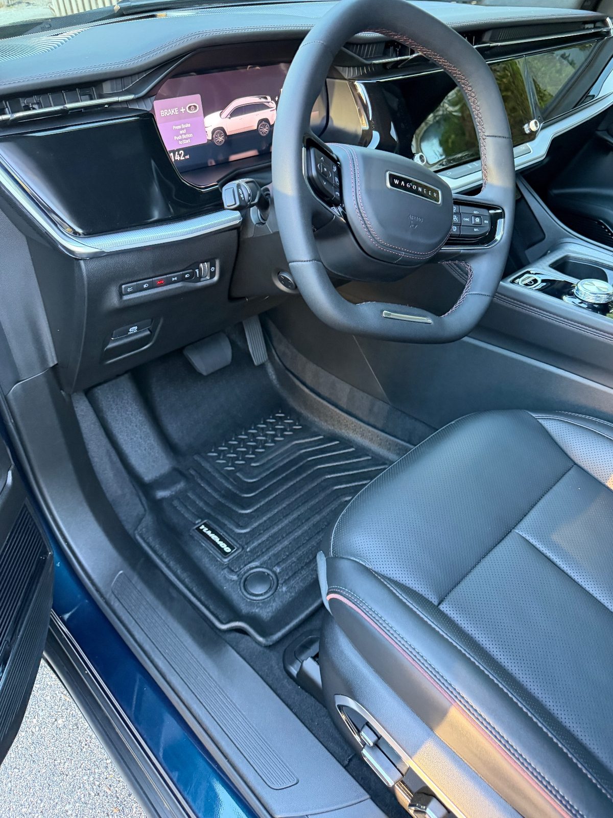 Driver footwell of a Jeep Wagoneer S after detailing, with a clean floor mat
