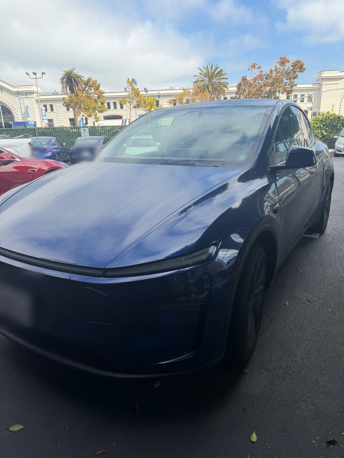 Blue Tesla Model Y front three-quarter before exterior detail, Downtown San Francisco