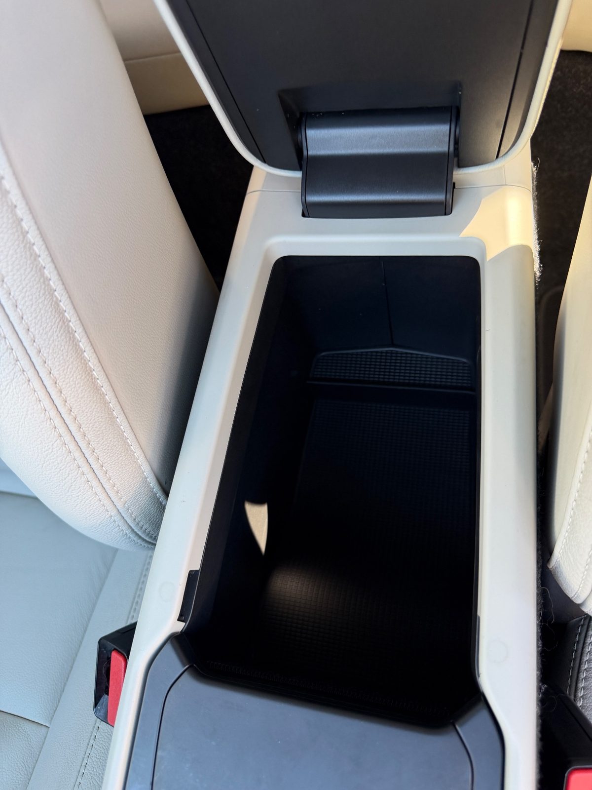 Clean empty centre armrest storage bin in a Volvo XC40 after detailing