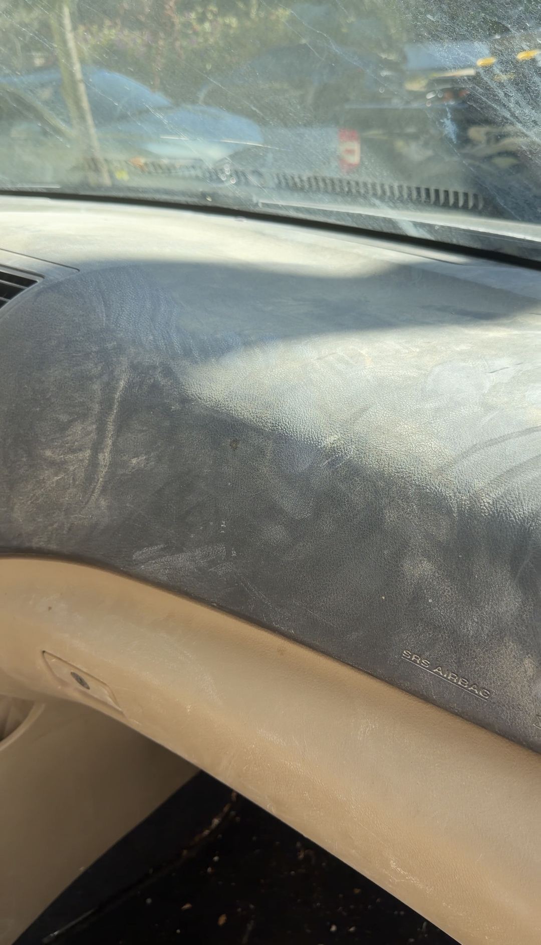 Dust-covered dashboard top and windshield inside a Toyota Highlander