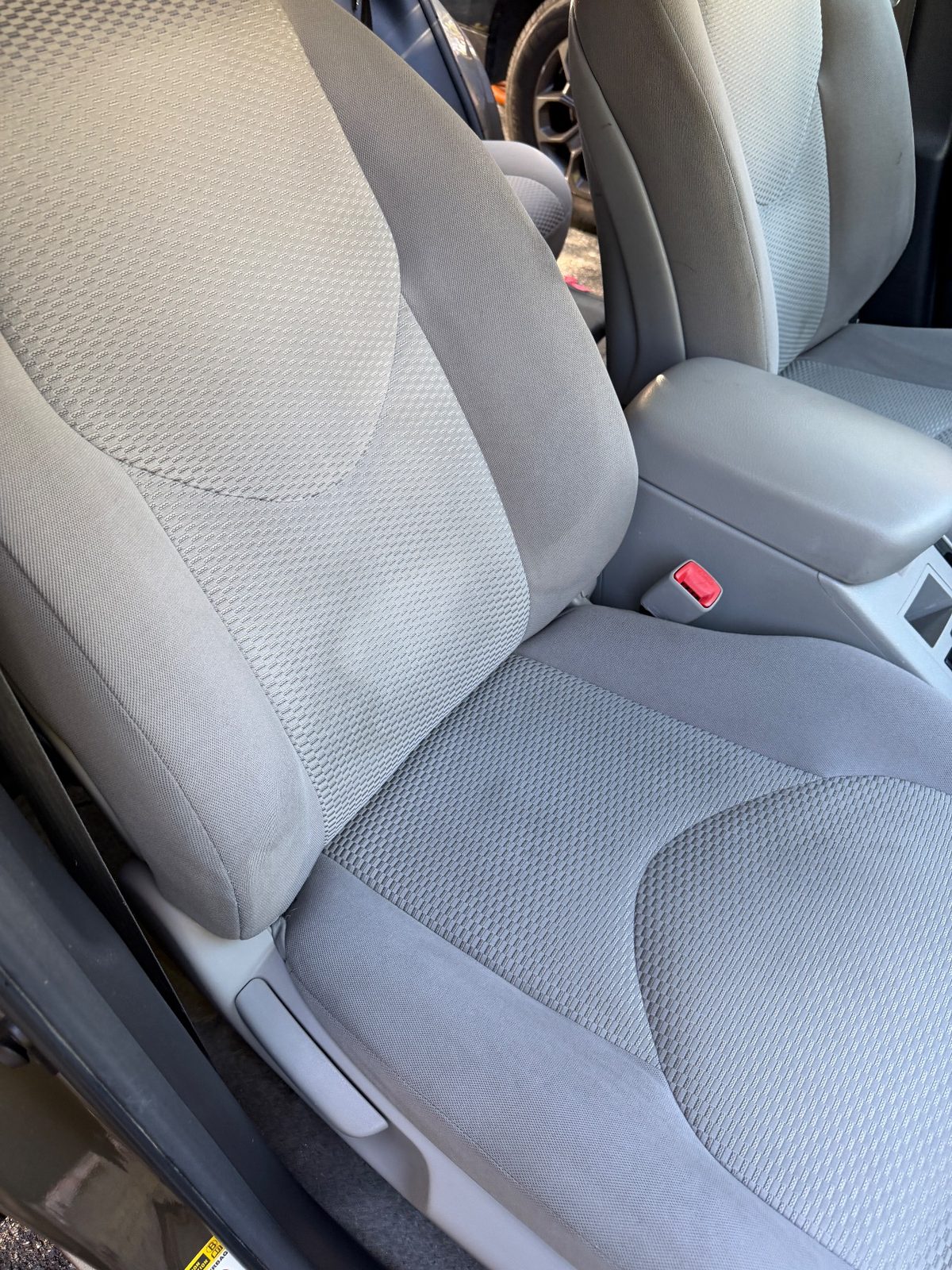 Clean front cloth seat of a 2011 Toyota RAV4 after detailing