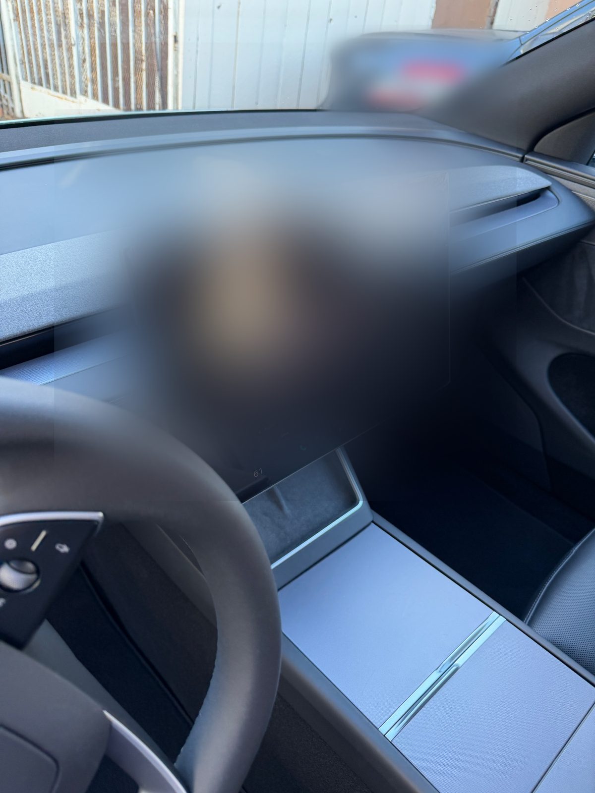 Clean dash and screen of a white Tesla Model Y after detailing