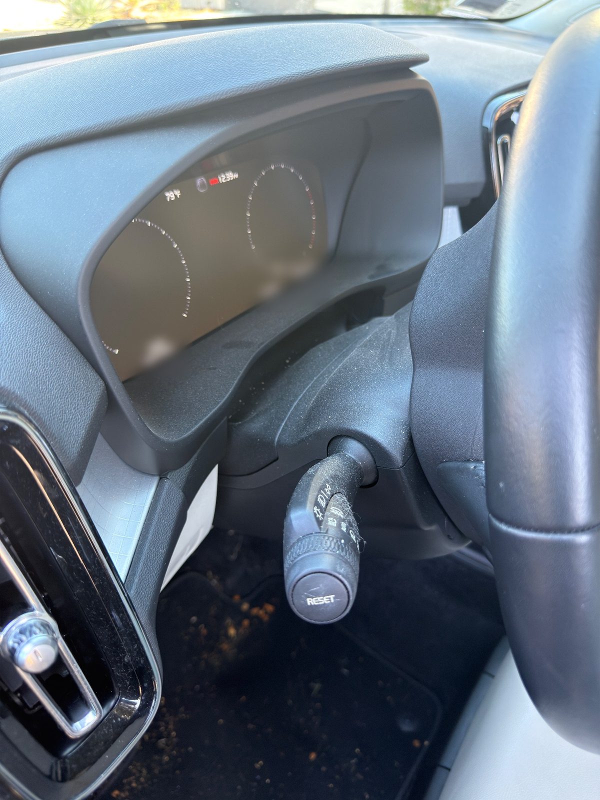 Dusty steering column stalk and instrument cluster hood in a Volvo XC40 before detailing