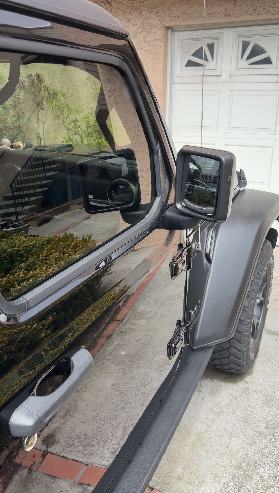 Clean black Jeep Wrangler front door, mirror and fender flare after an exterior detail