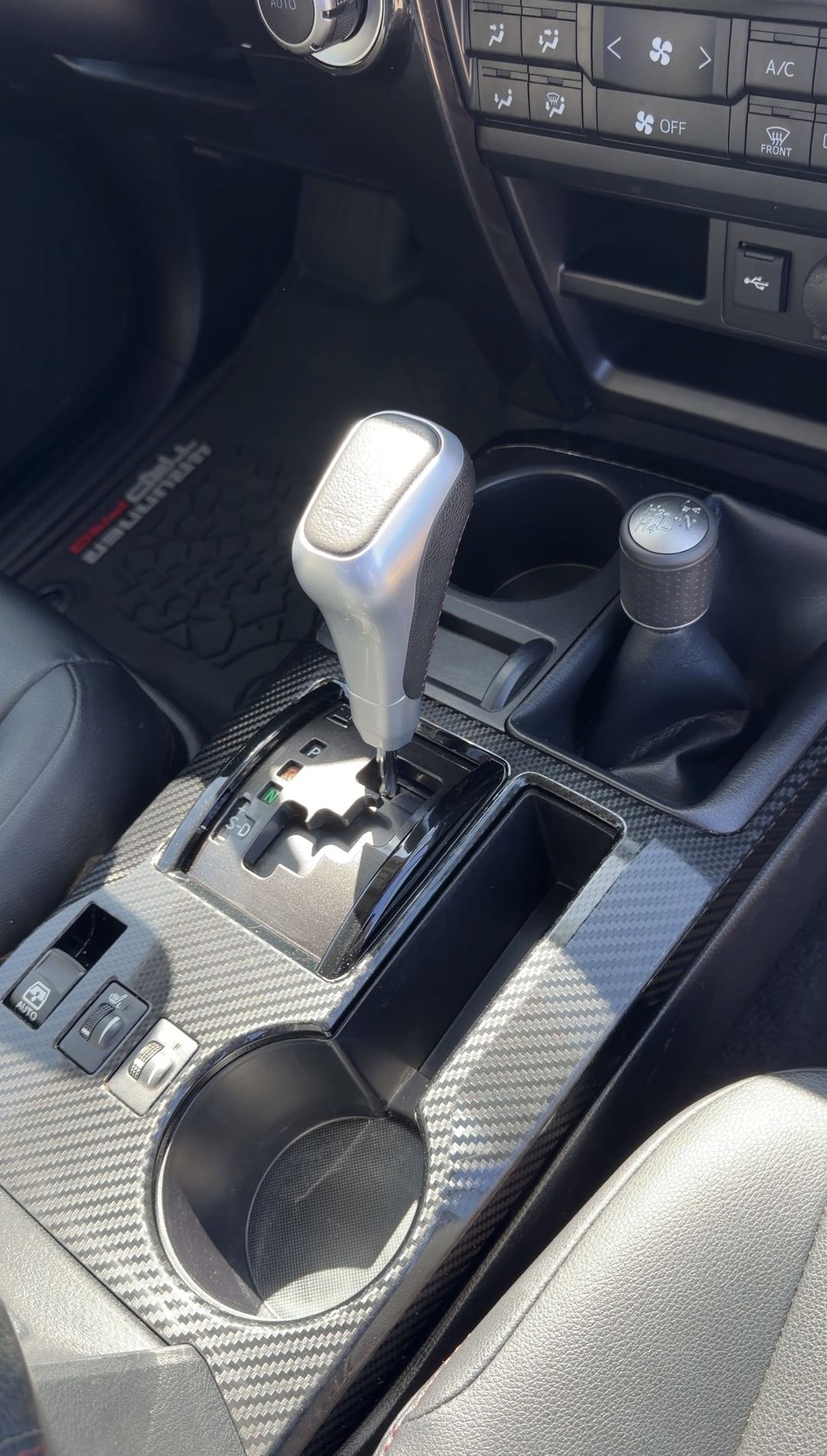Clean center console with TRD shift knob and carbon-pattern trim in a Toyota 4Runner