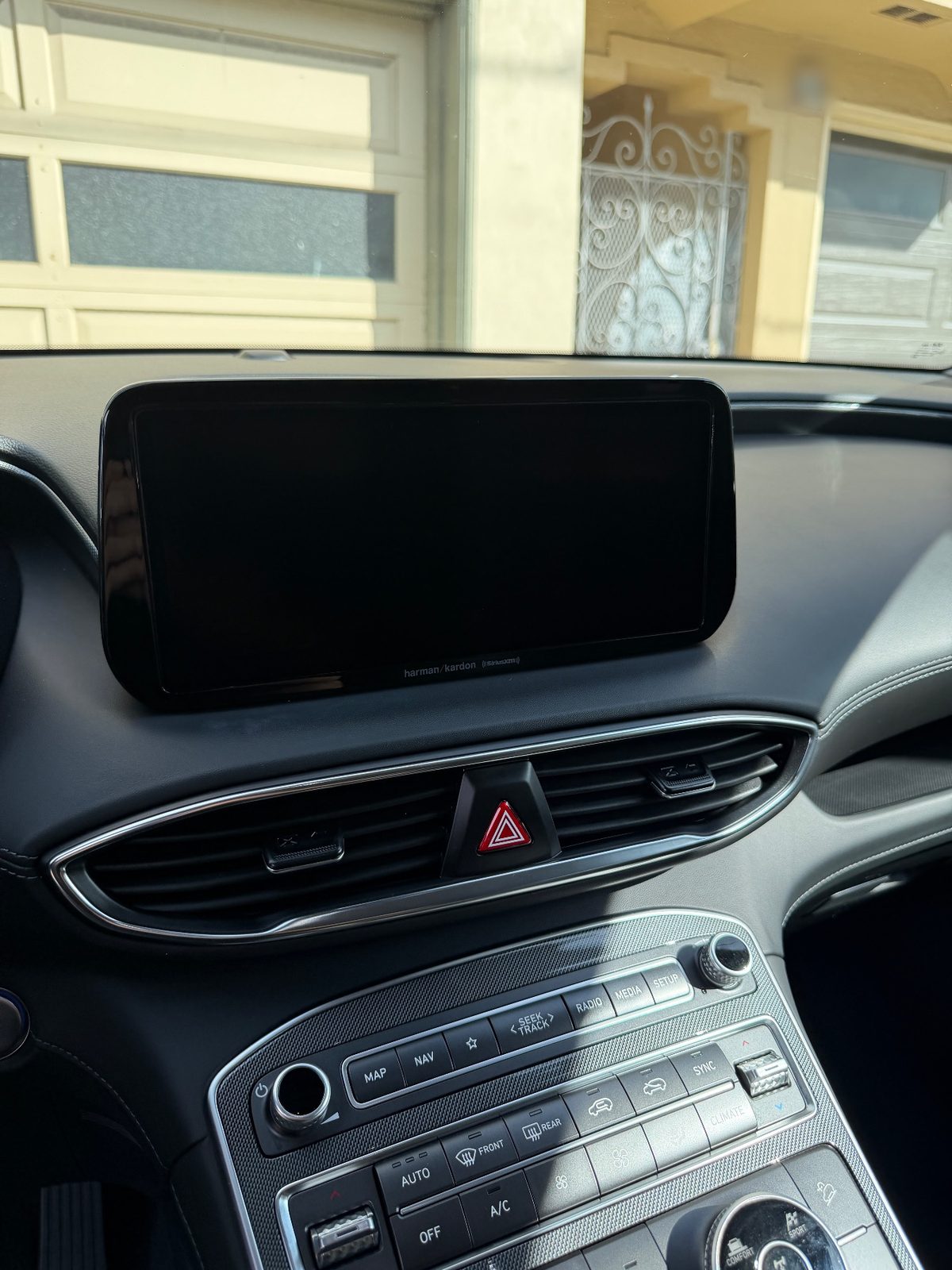 Clean infotainment screen and centre stack of a Hyundai Santa Fe after detailing