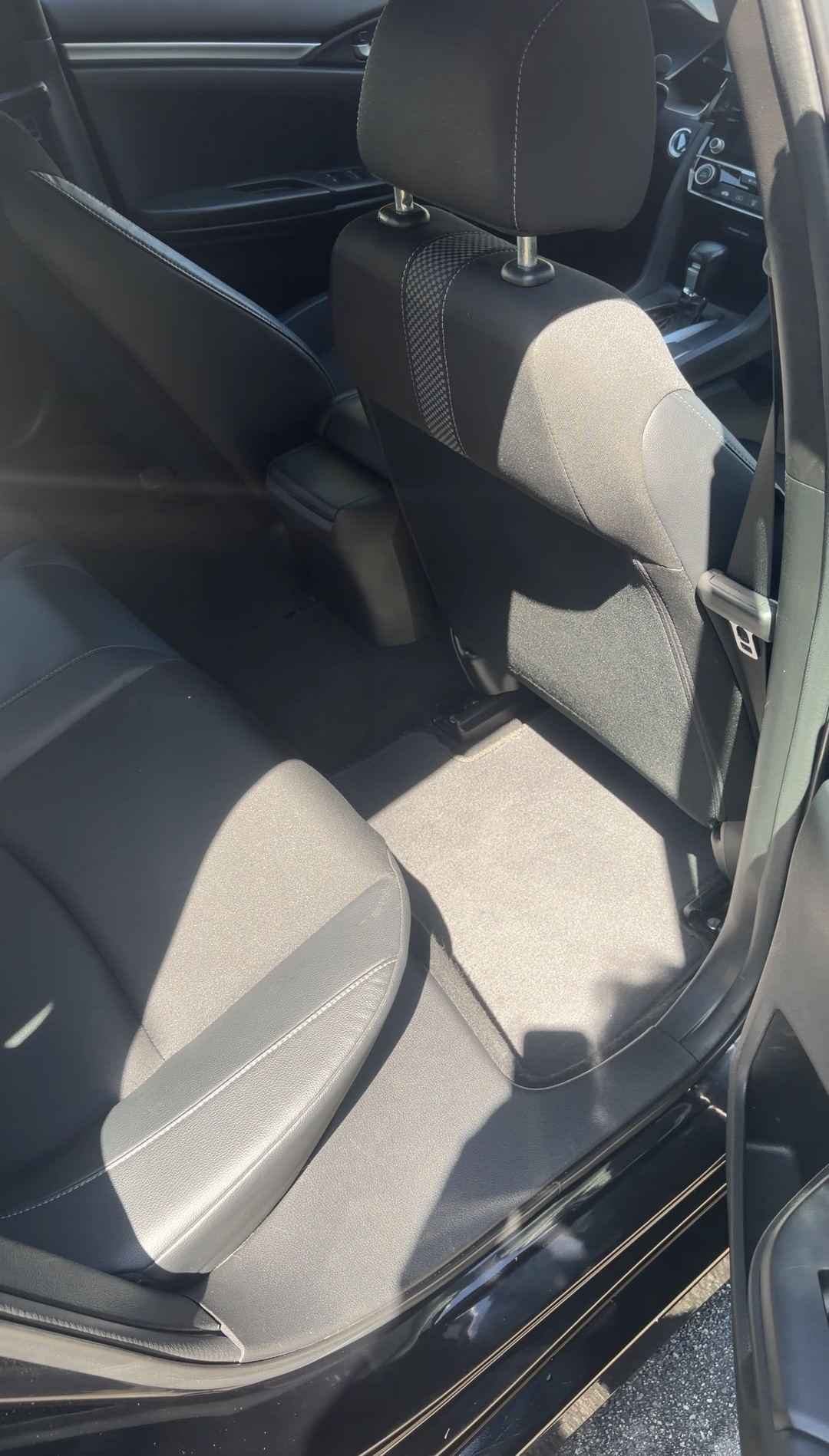 Vacuumed rear floor mat in a Honda Civic after the interior detail