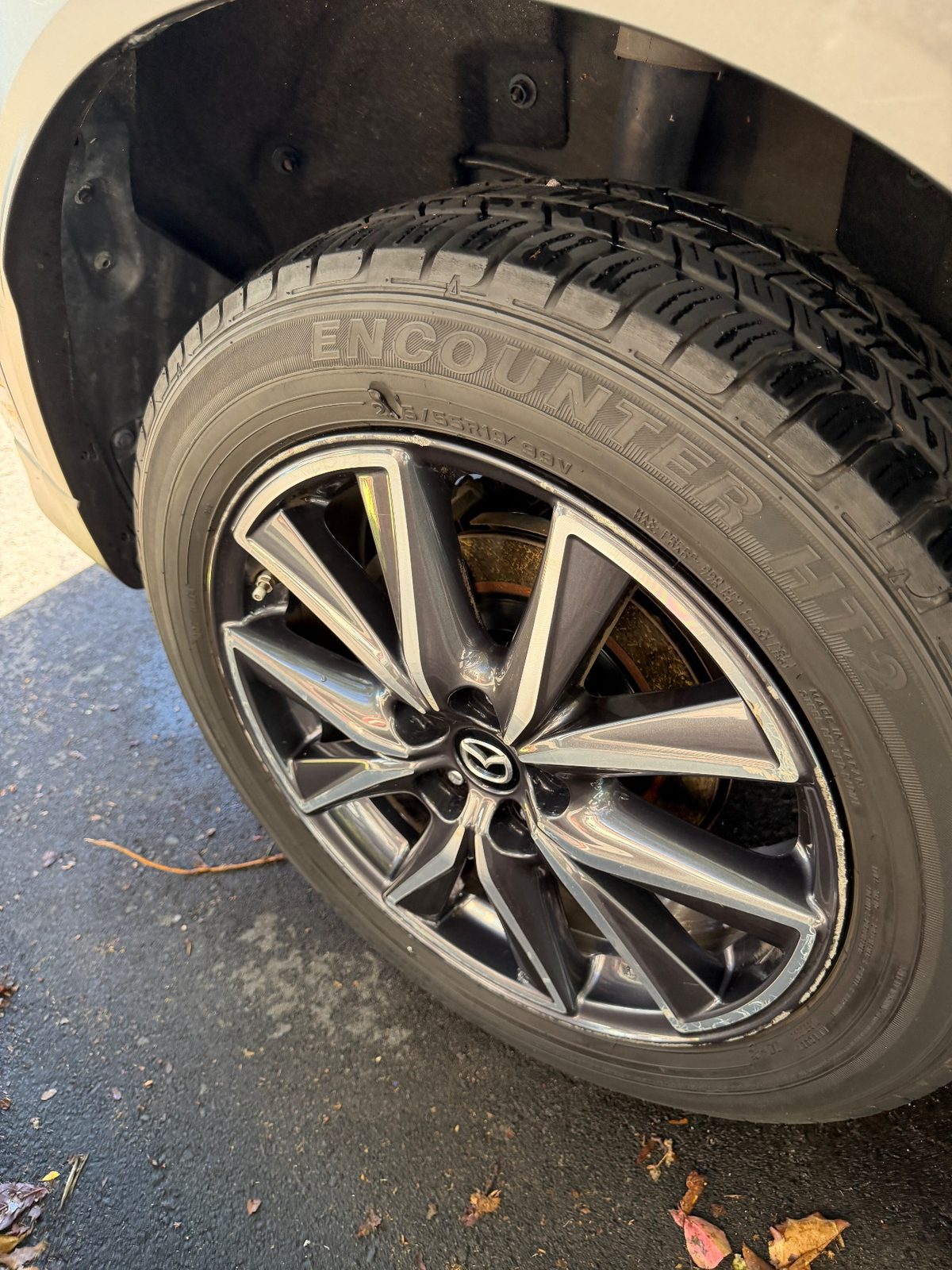 Cleaned 19-inch alloy wheel and dressed tyre on a dark blue Mazda CX-5