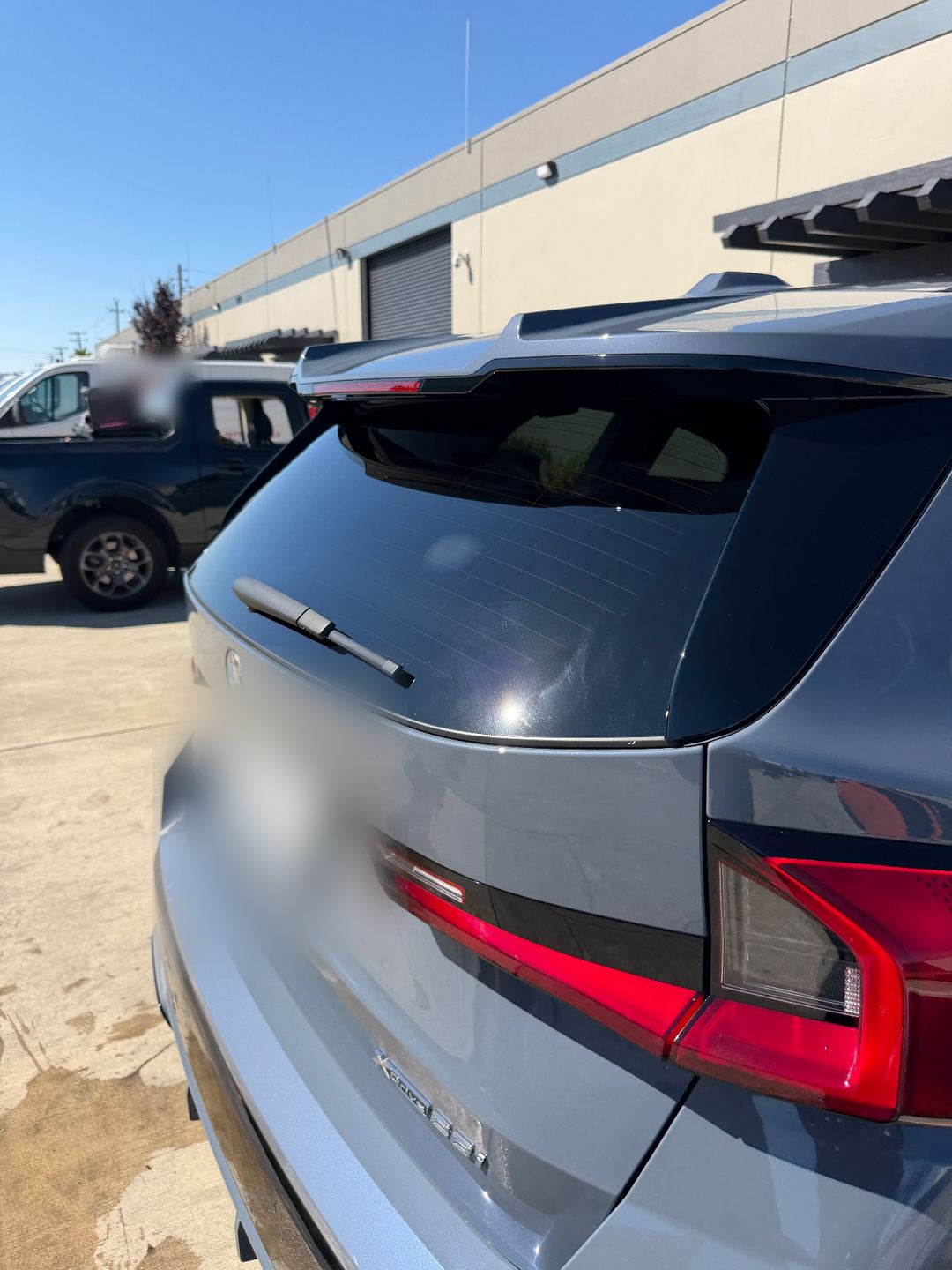 Rear of a grey BMW X1 after washing