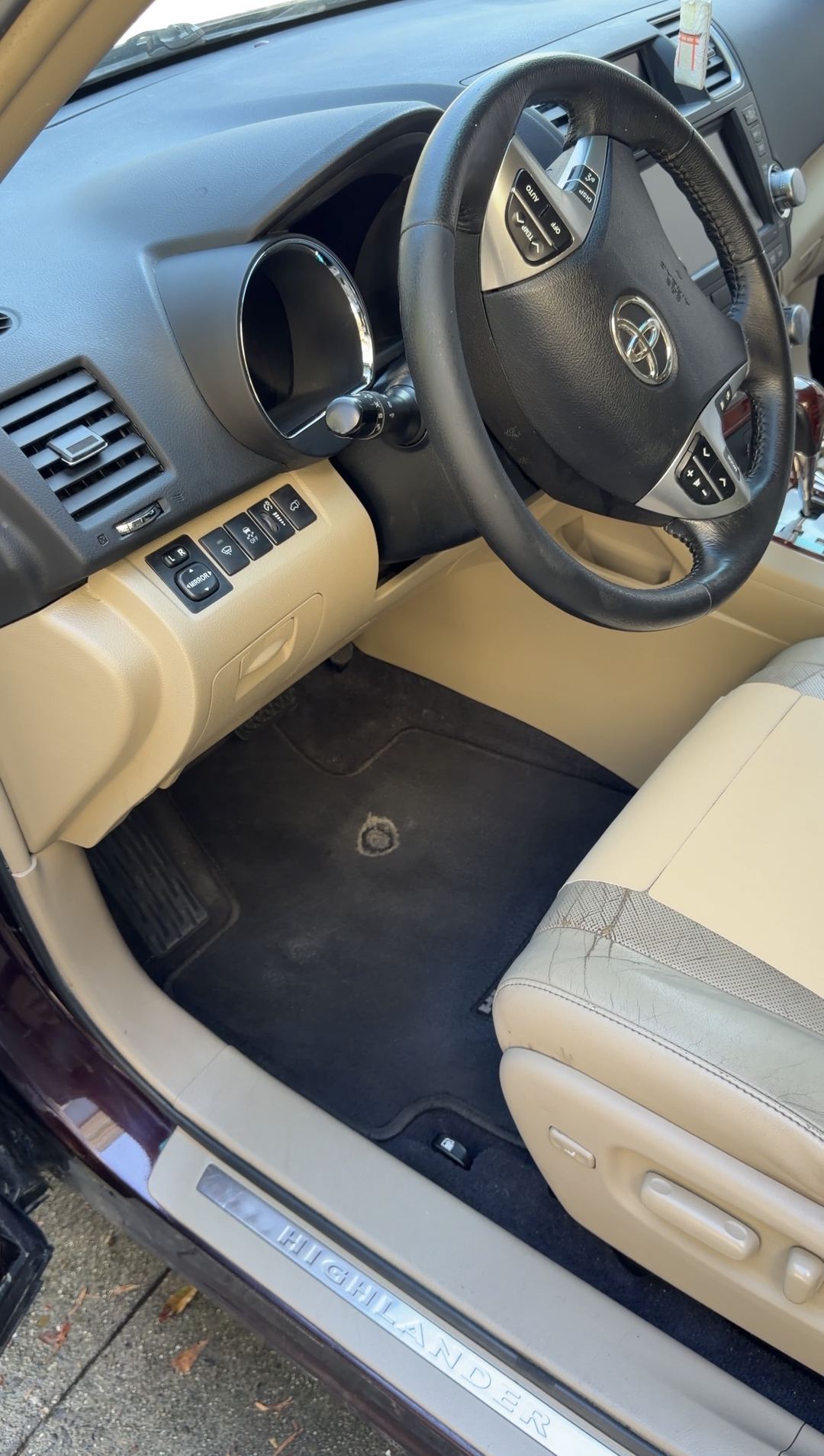 Clean driver footwell, HIGHLANDER sill plate and dash of a Toyota Highlander after interior detailing