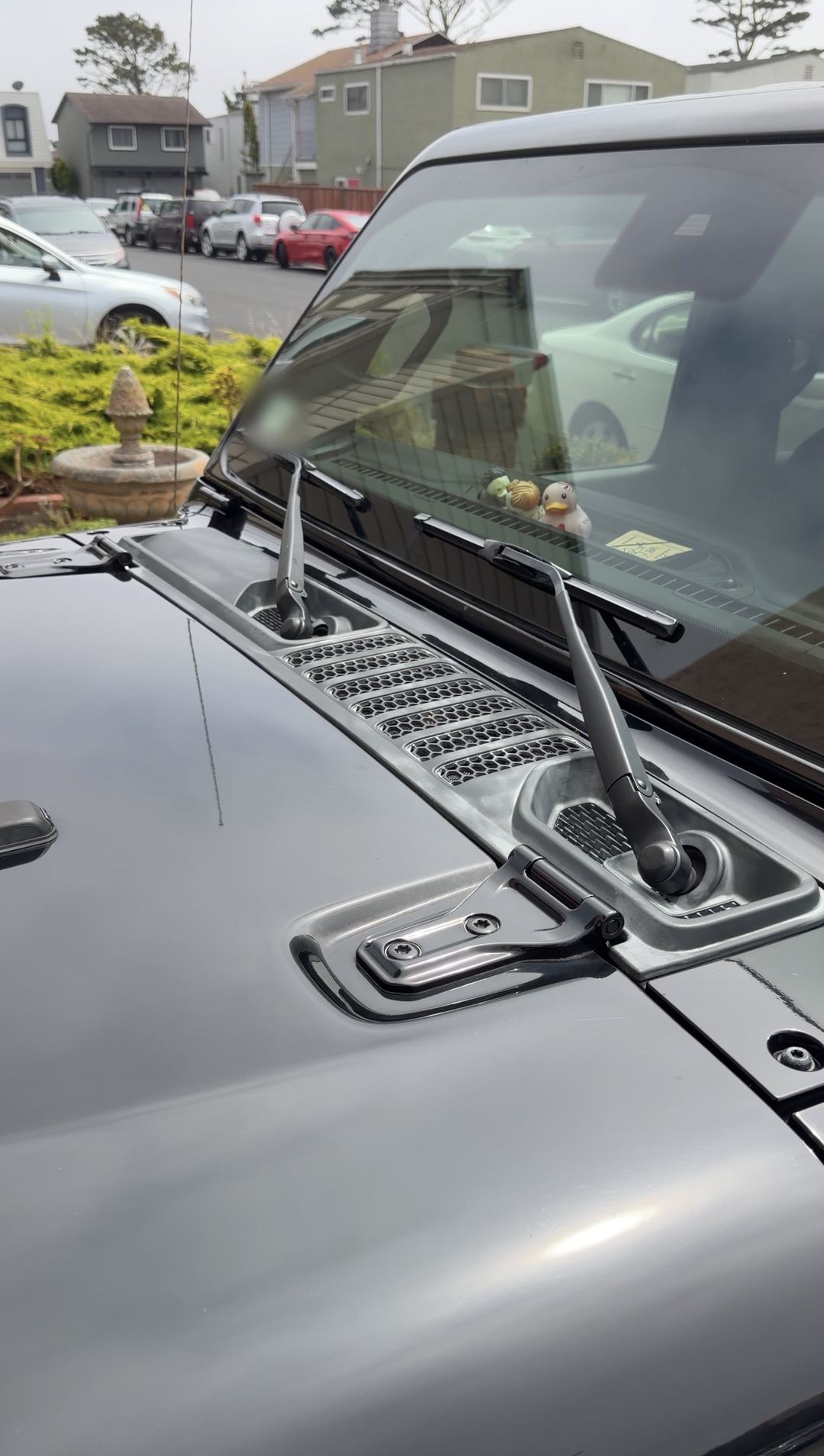 Jeep Wrangler cowl, antenna and hood after cleaning, rubber ducks on the dash