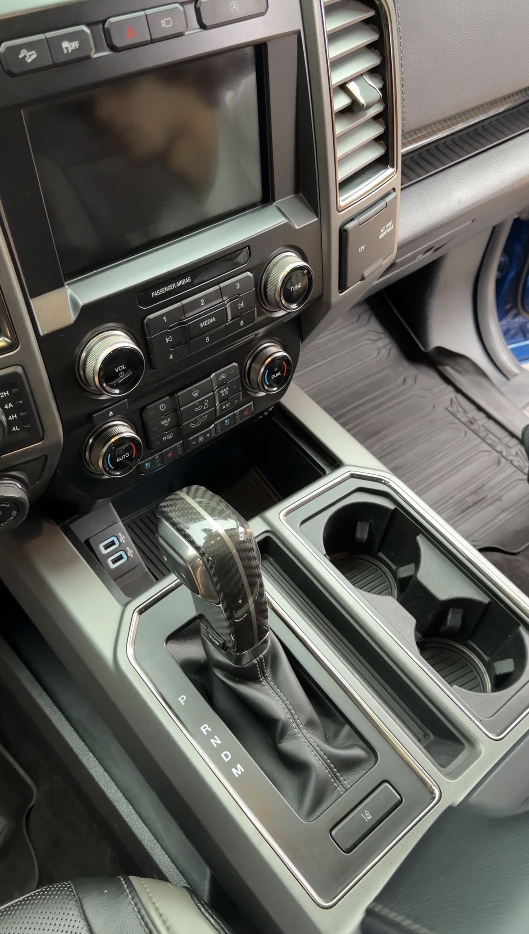Clean centre console and cupholders of a Ford F-150 Raptor after detailing