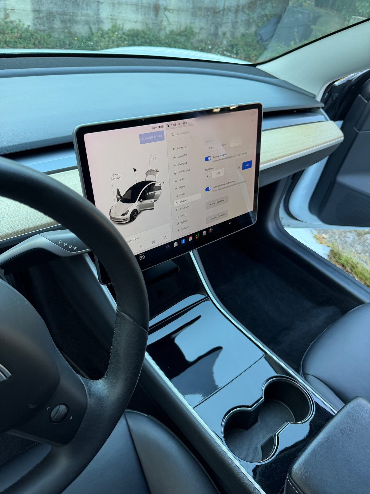 Clean dashboard and centre console of a white Tesla Model 3 after detailing