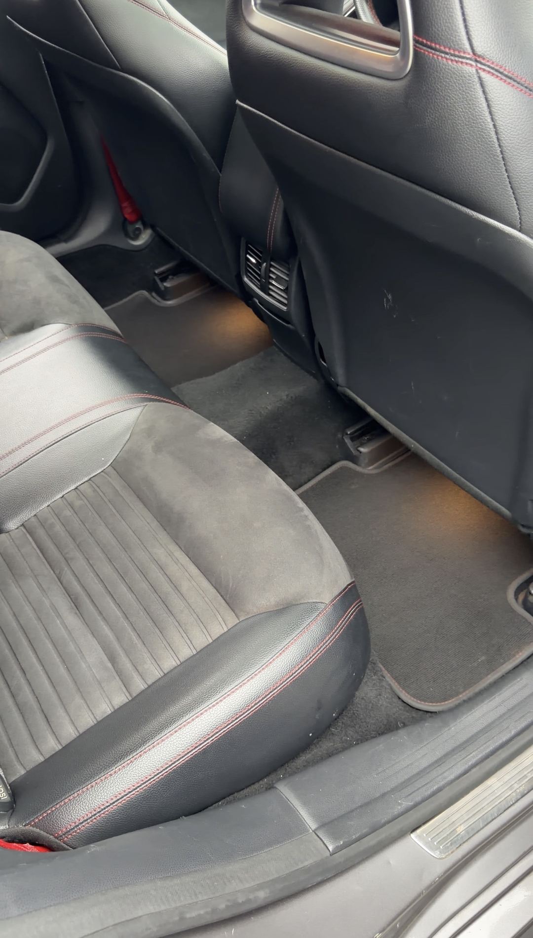 Rear footwell and rear seat of a Mercedes-Benz CLA250 before interior detailing