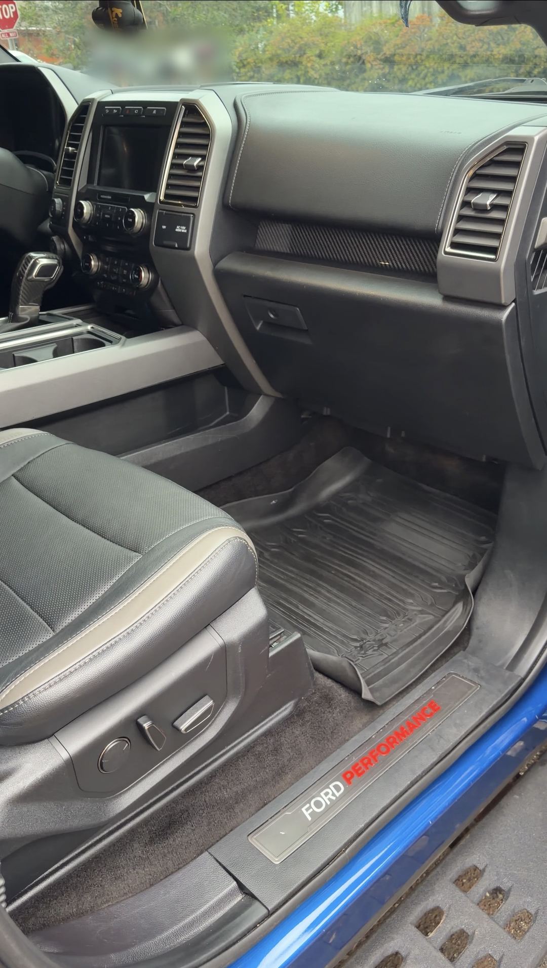 Clean passenger footwell of a Ford F-150 Raptor after an interior detail