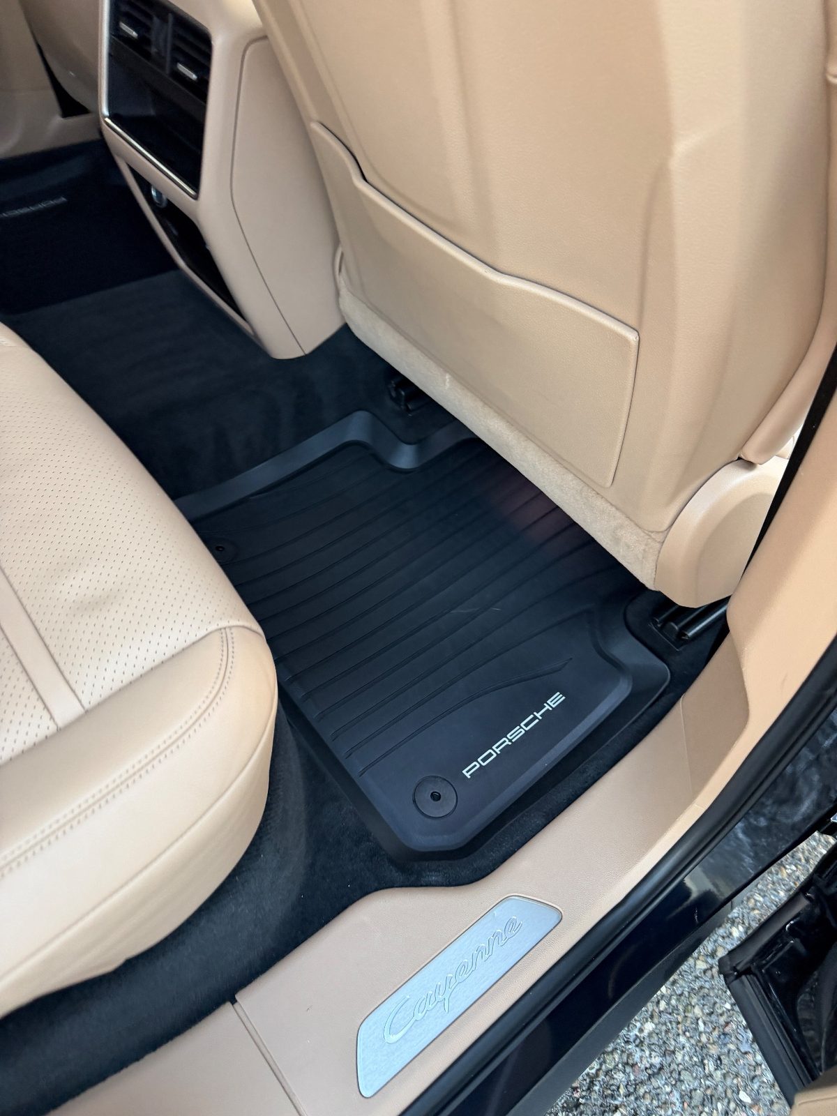 Clean rear footwell of a Porsche Cayenne after detailing, rubber mat wiped and free of crumbs