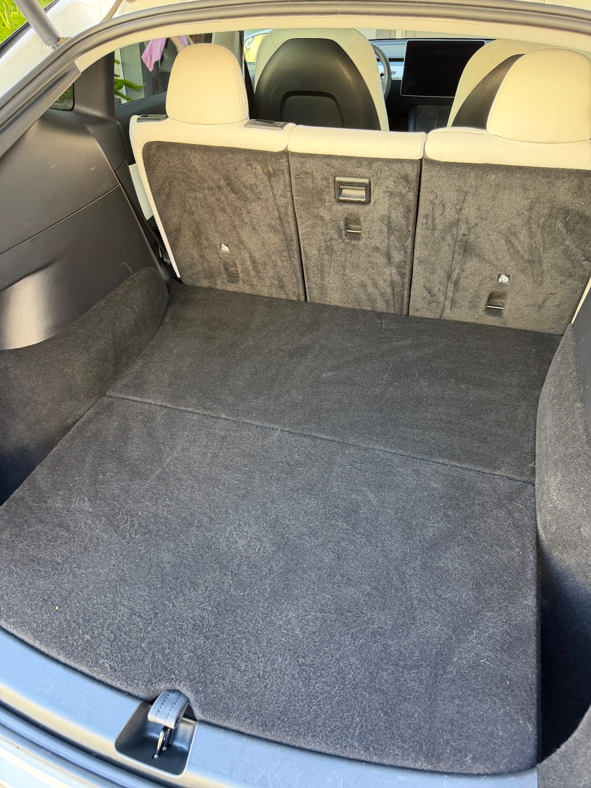 Vacuumed cargo area of a white Tesla Model Y after detailing