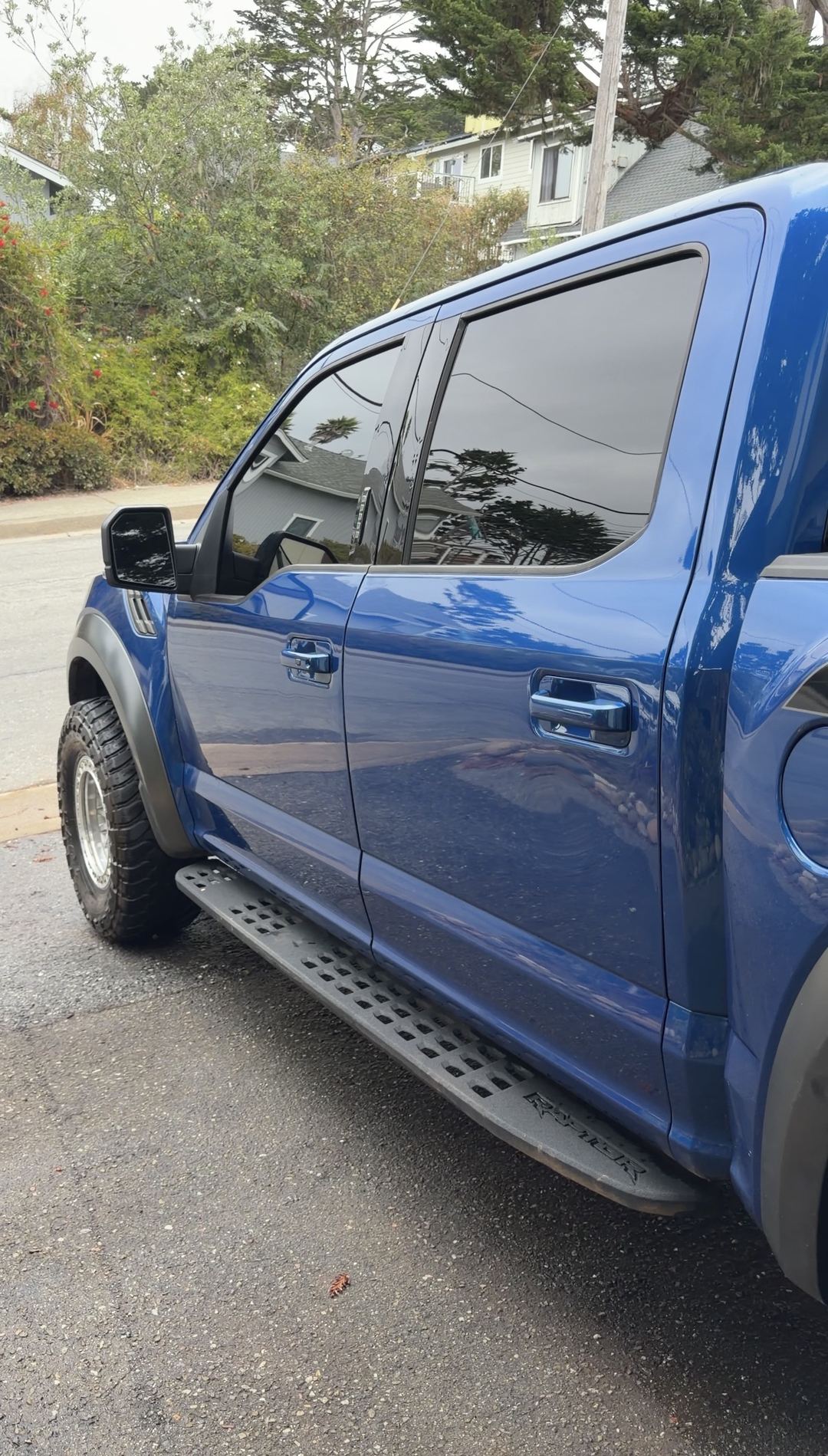Clean driver's side of a blue Ford F-150 Raptor after a mobile detail